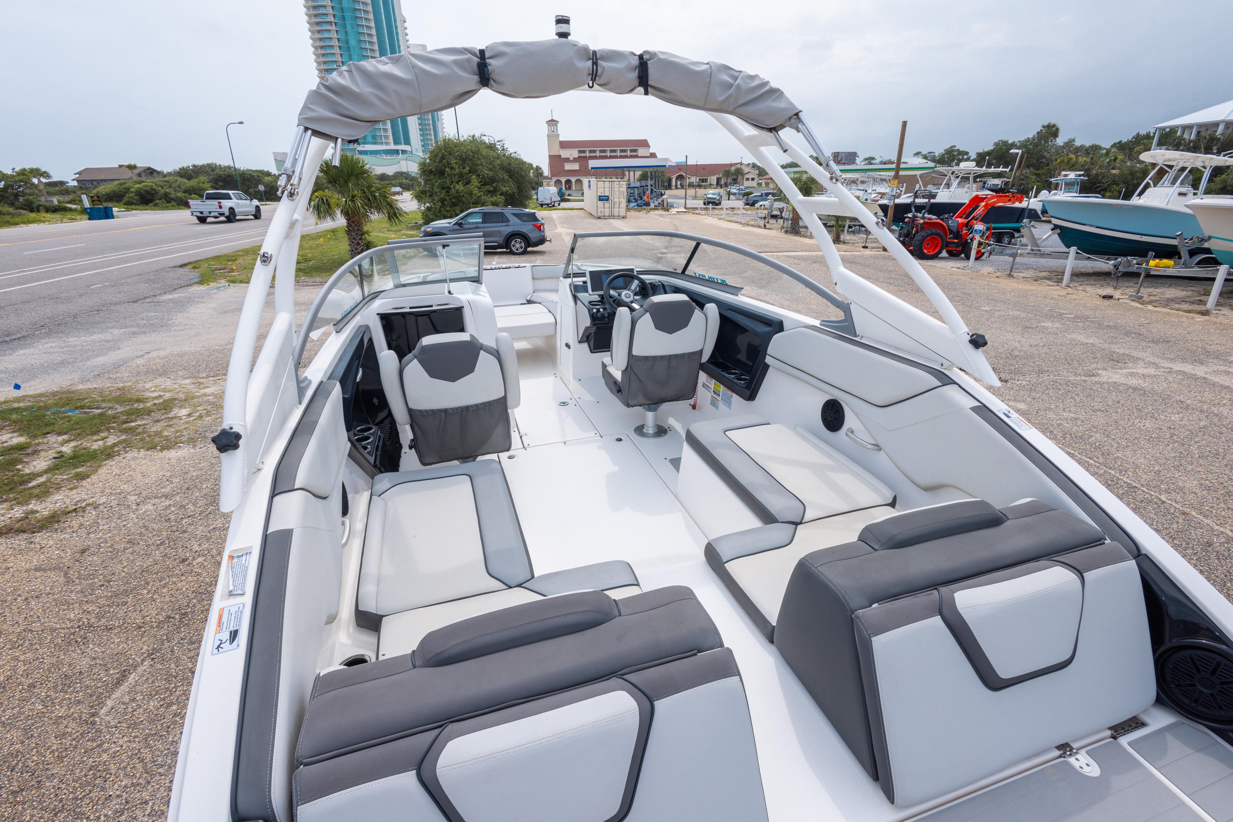 2021 Yamaha Boats AR250 interior with sleek seating and modern design in a marina setting.