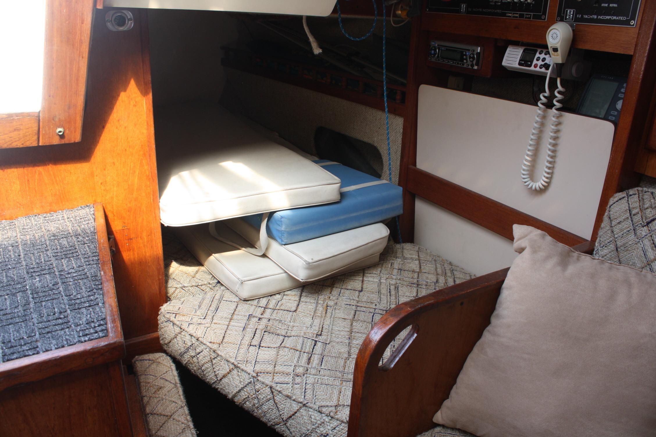 Interior of 1981 S2 9.2A sailboat with cushions and communication equipment.