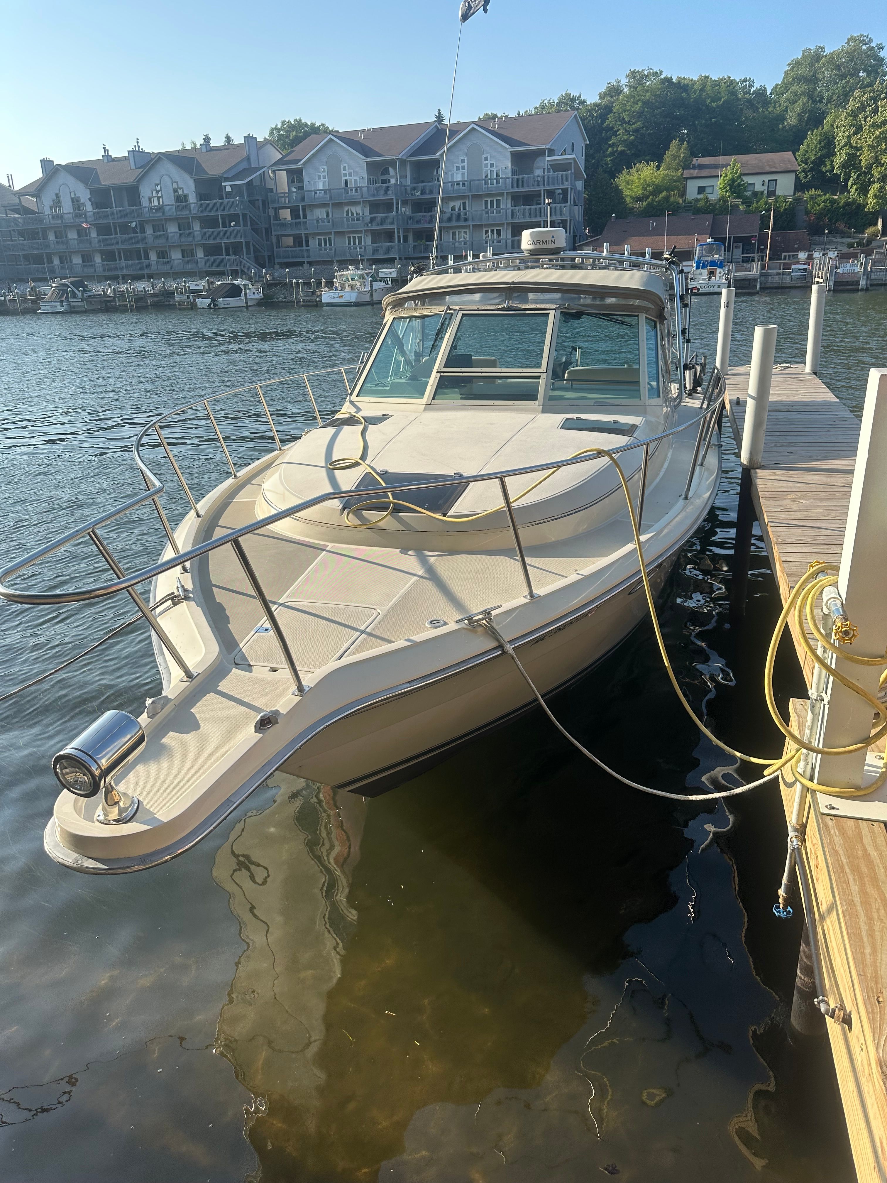 1986 Tiara Yachts 3100 Open at dock, calm water.