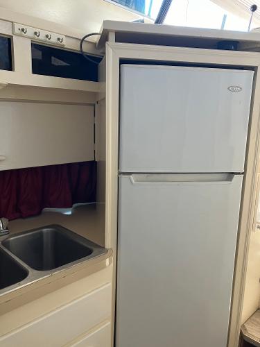 1985 Cruisers Yachts 338 Chateau Vee kitchen with sink and refrigerator.