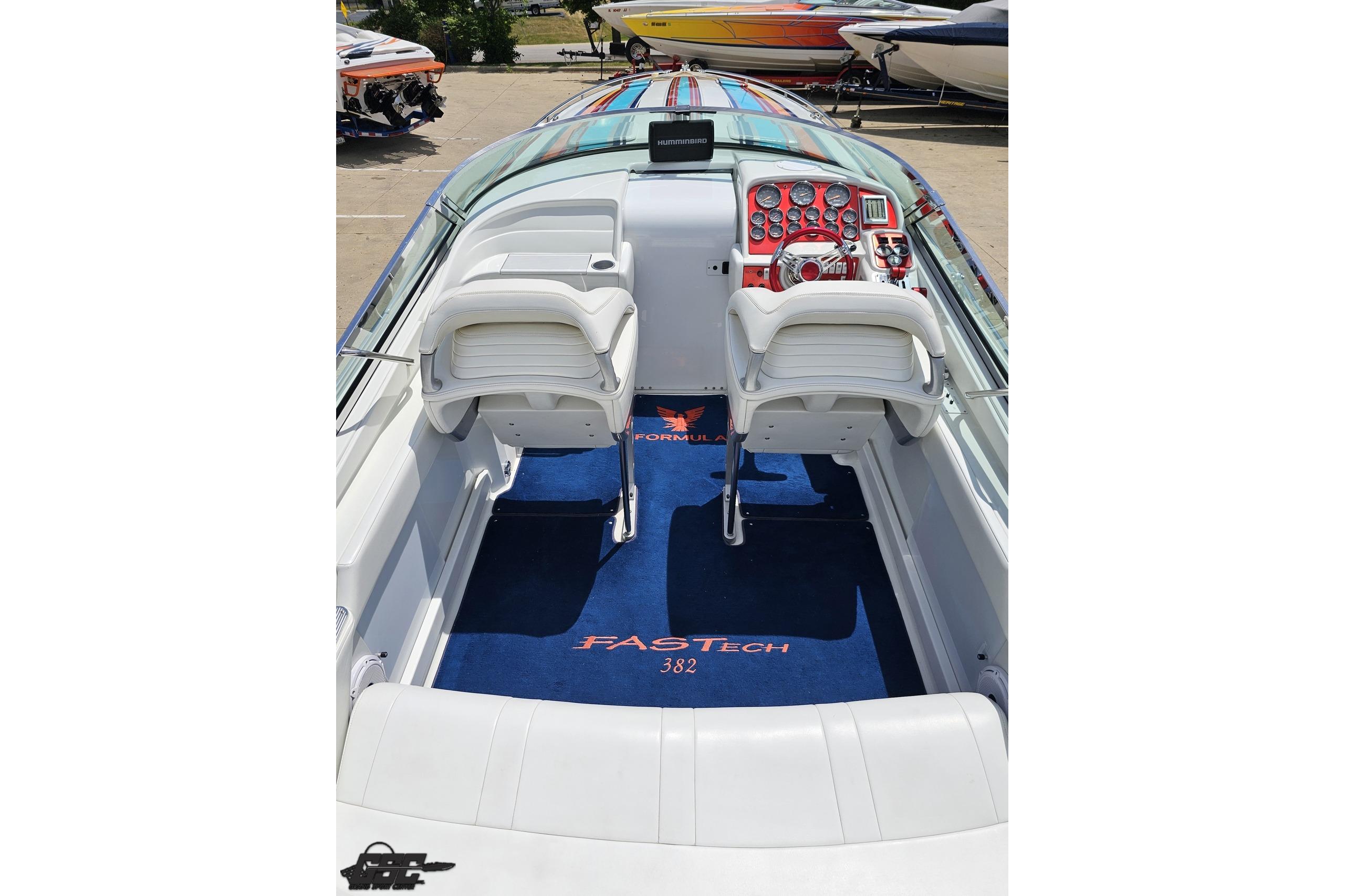 2002 Formula 382 FASTech boat interior with white seating and detailed dashboard.