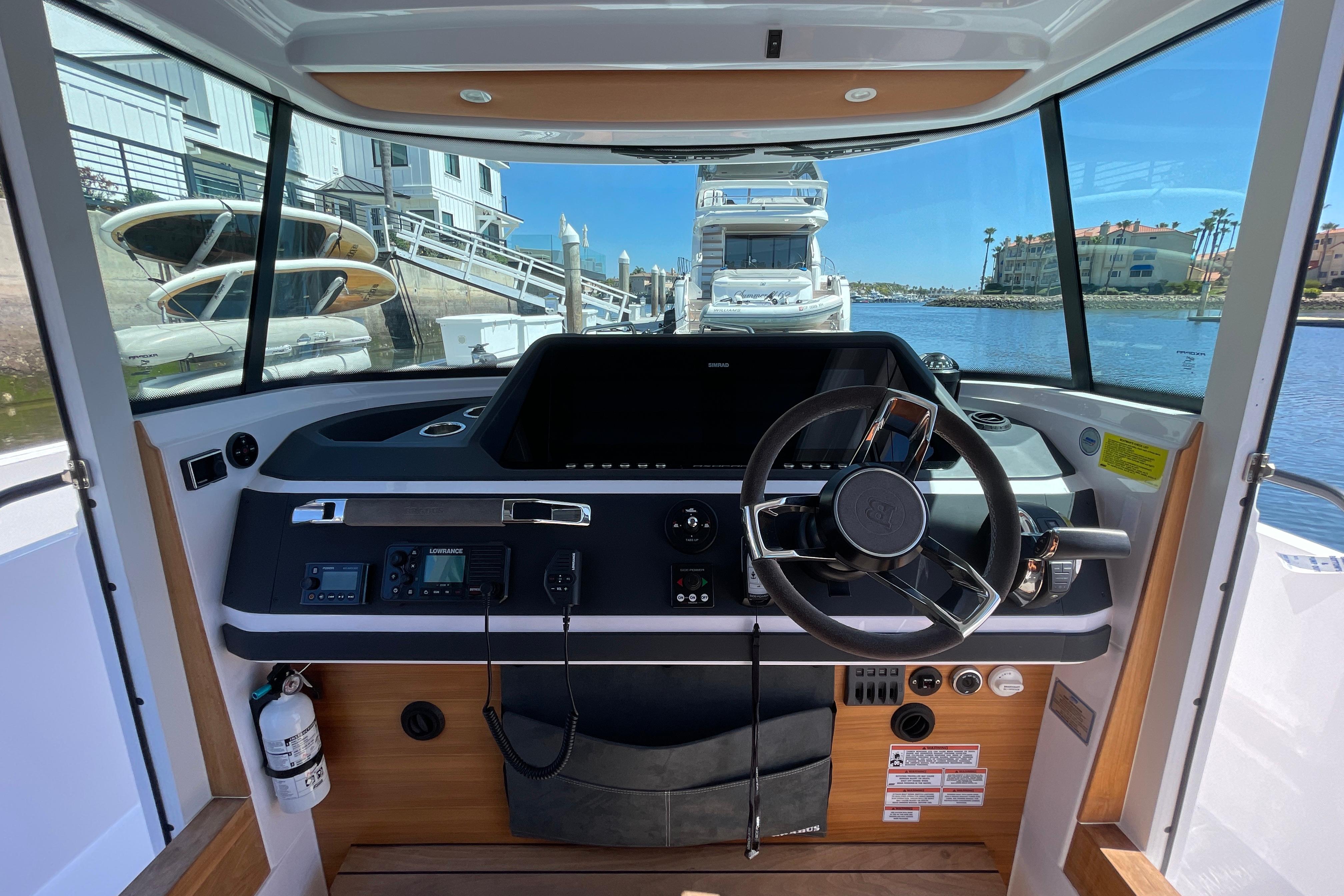 2022 Axopar Brabus 28 Cabin helm with modern controls and waterfront view.