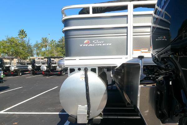 2024 Sun Tracker Fishin' Barge 22 XP3 pontoon boat in a parking lot.