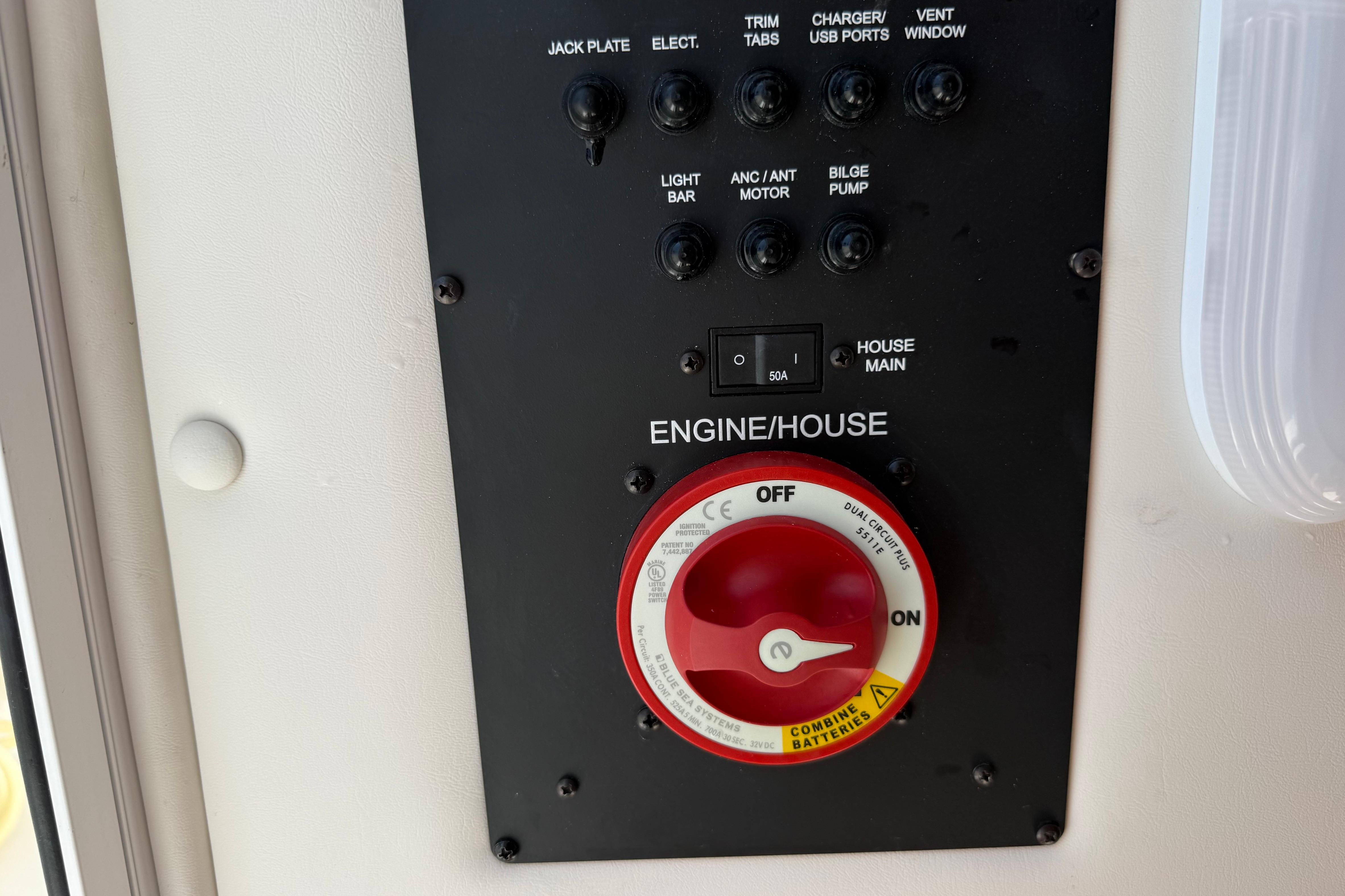 Control panel of 2023 Regulator 26XO boat with switches and battery selector.