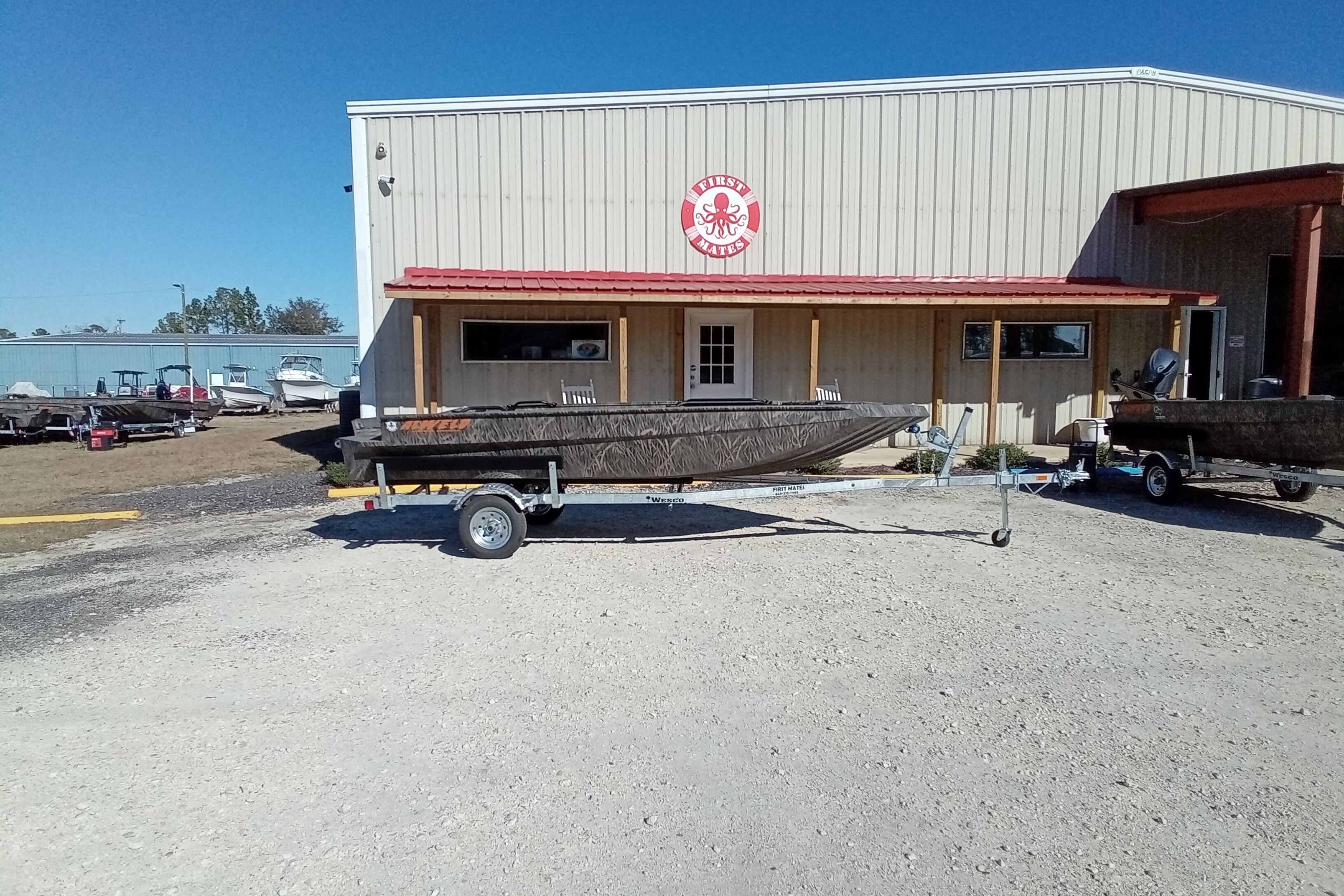 2026 Alweld 1652 Invader boat on trailer outside a metal building.