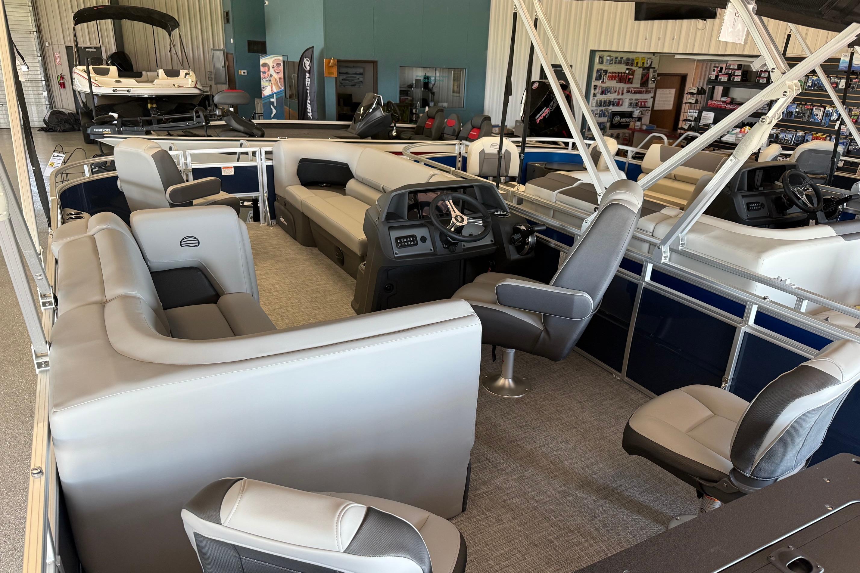 2026 Sun Tracker SportFish 20 DLX pontoon boat interior with plush seating and modern helm.