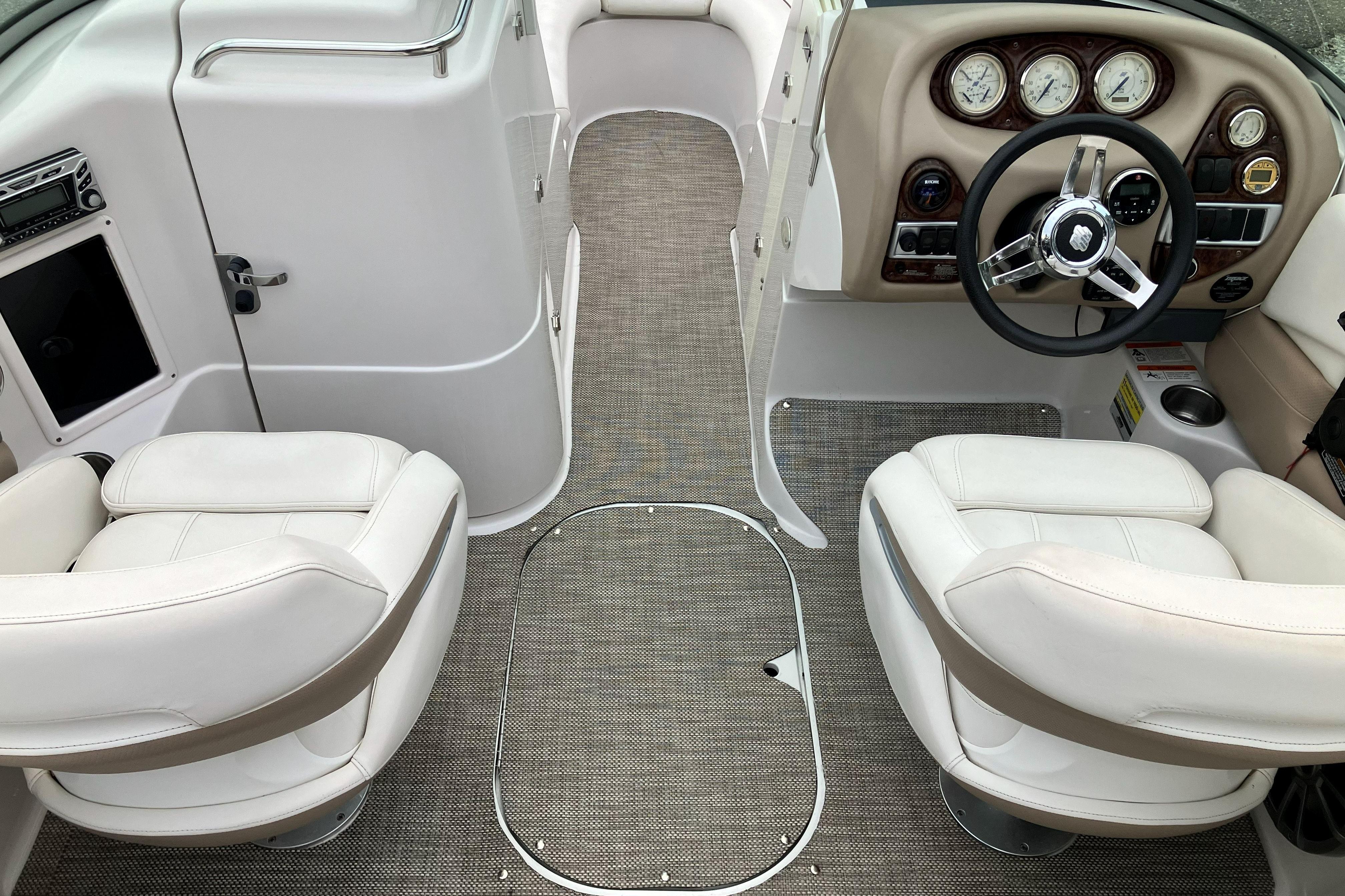 2006 Four Winns 240 Horizon boat interior with white seats and modern dashboard.