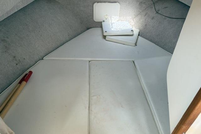 Interior cabin of 2006 Parker 2520 SL Sport Cabin boat, featuring cushioned seating.