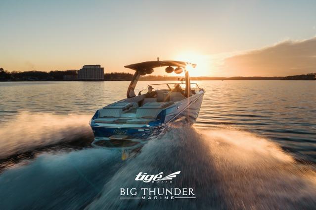 2026 Tigé Z3 boat cruising on a lake at sunset, Big Thunder Marine logo visible.