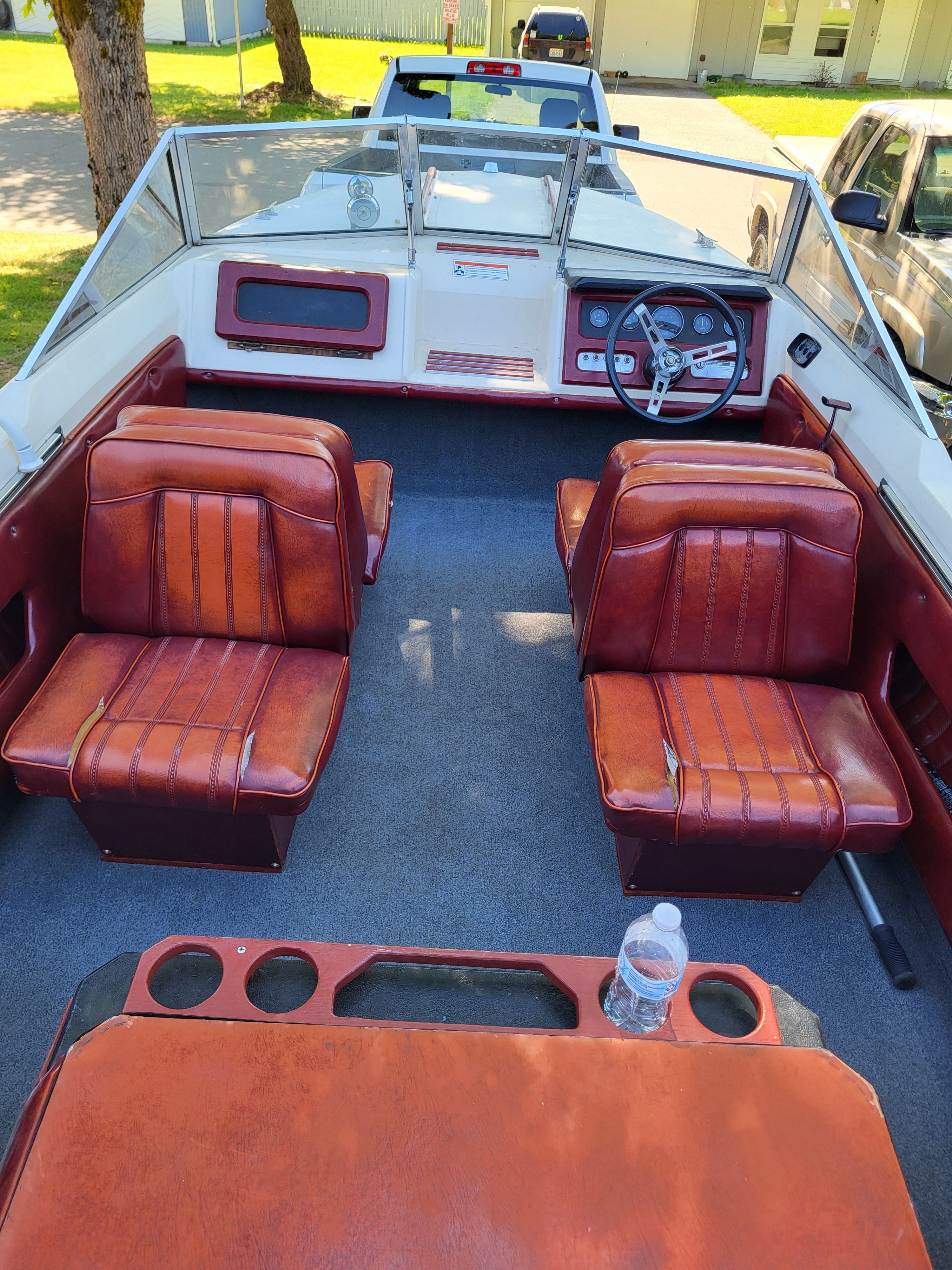 Interior of a 1977 Bayliner Jamaica boat with red leather seats.