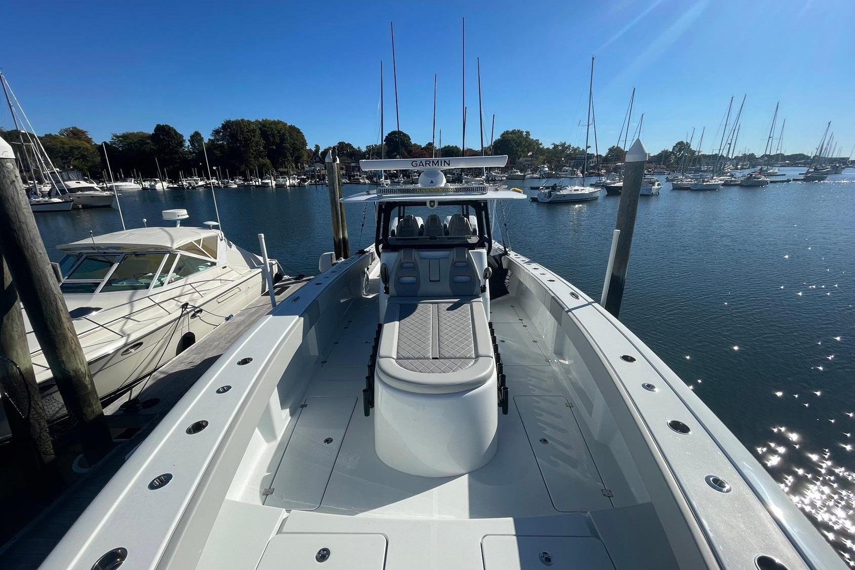 2024 Freeman 42LR boat docked in a marina with clear blue skies.