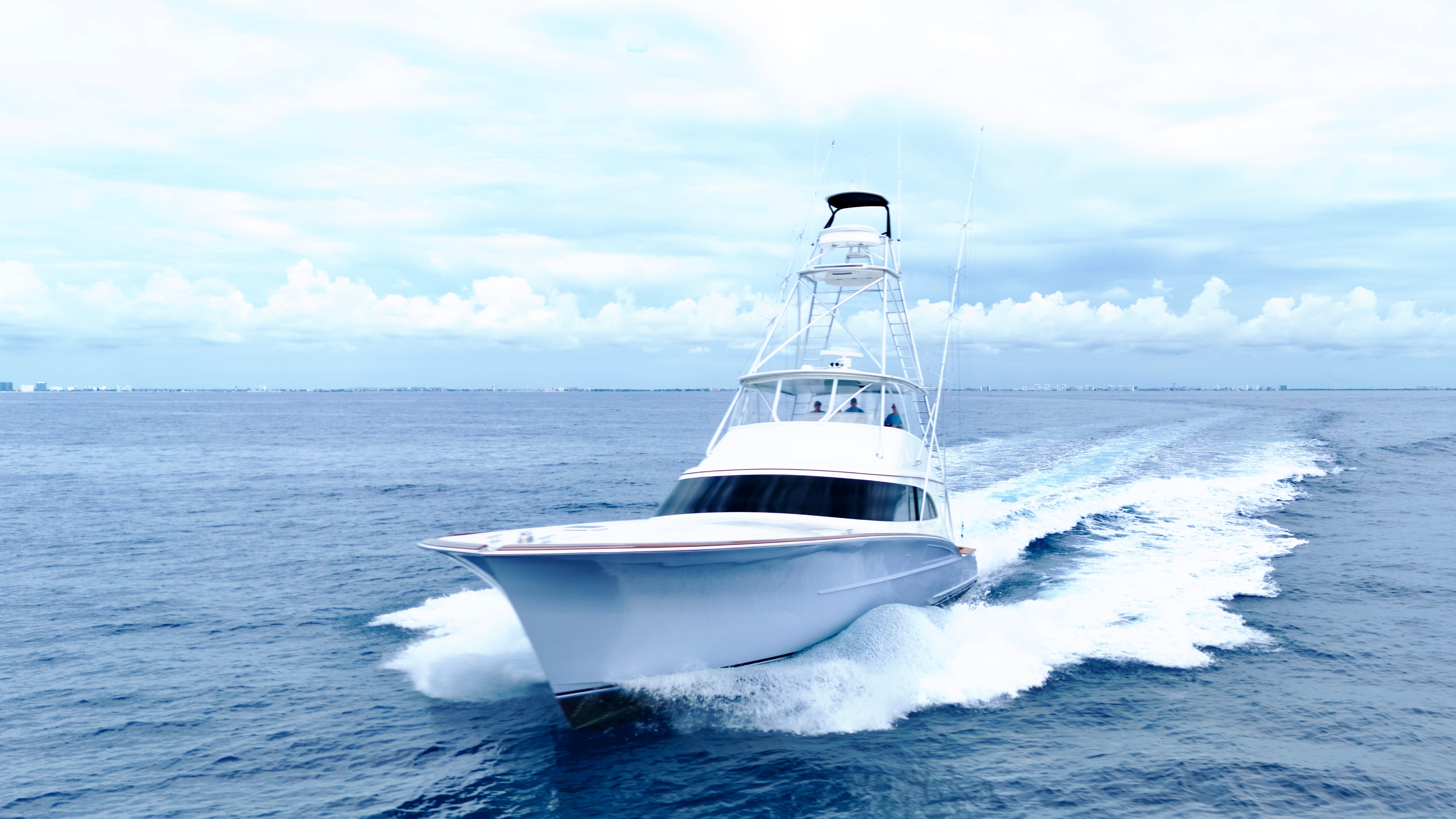 A sleek sportfish boat by Titan Yachts speeds across the open sea.