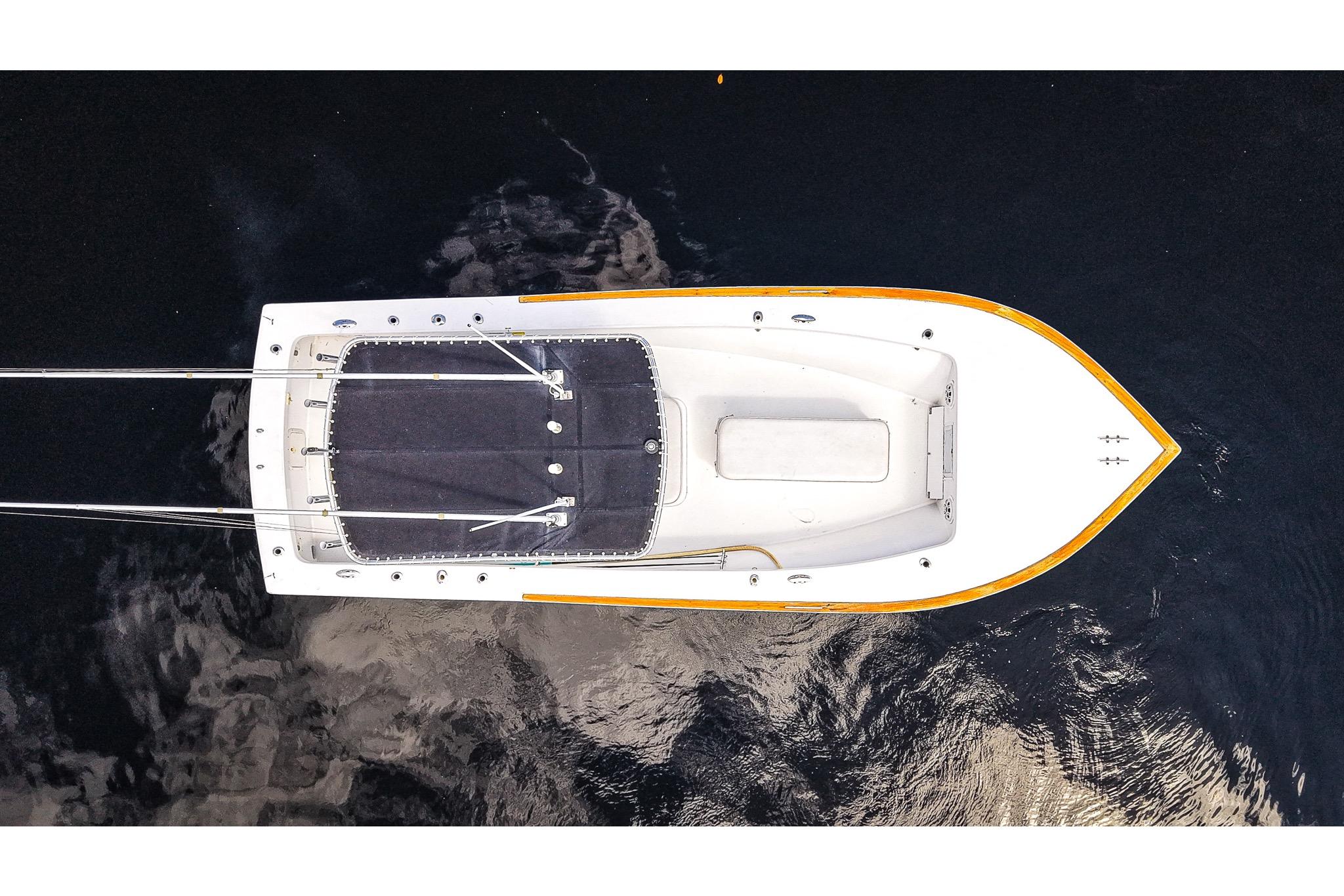 Aerial view of 1977 Scarborough 27 CC boat on dark water.