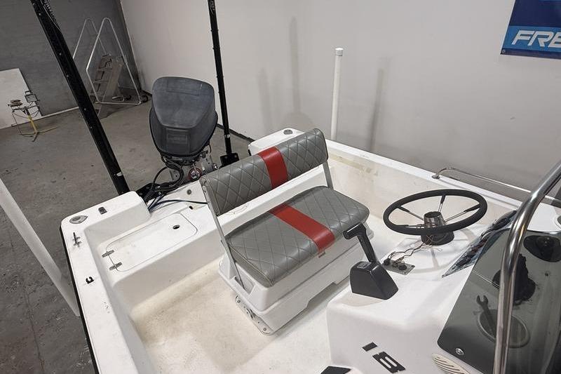 1996 Century 1800 Center Console boat interior with steering wheel and seating.