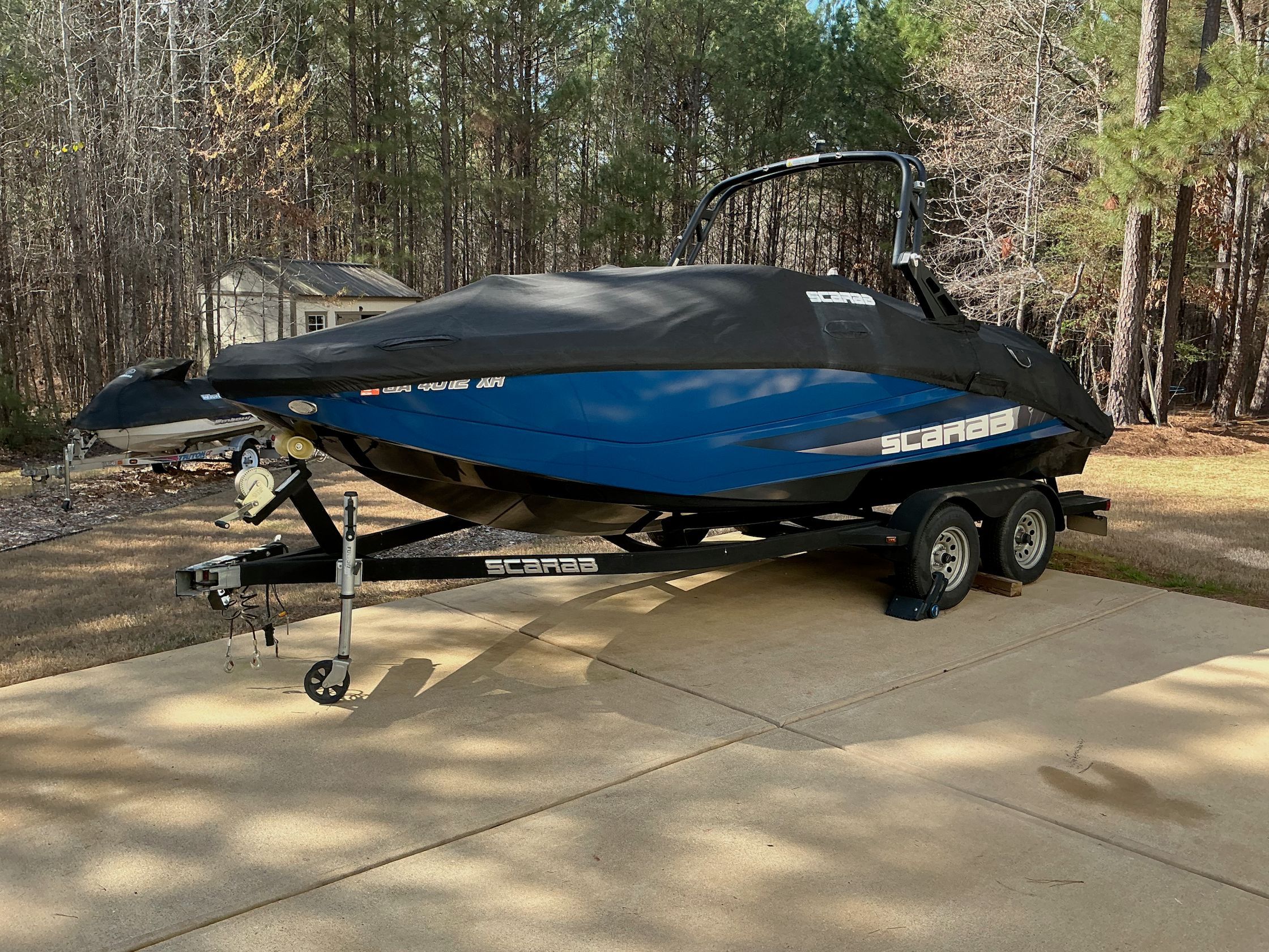 2021 Scarab 215 ID boat parked on trailer outdoors.