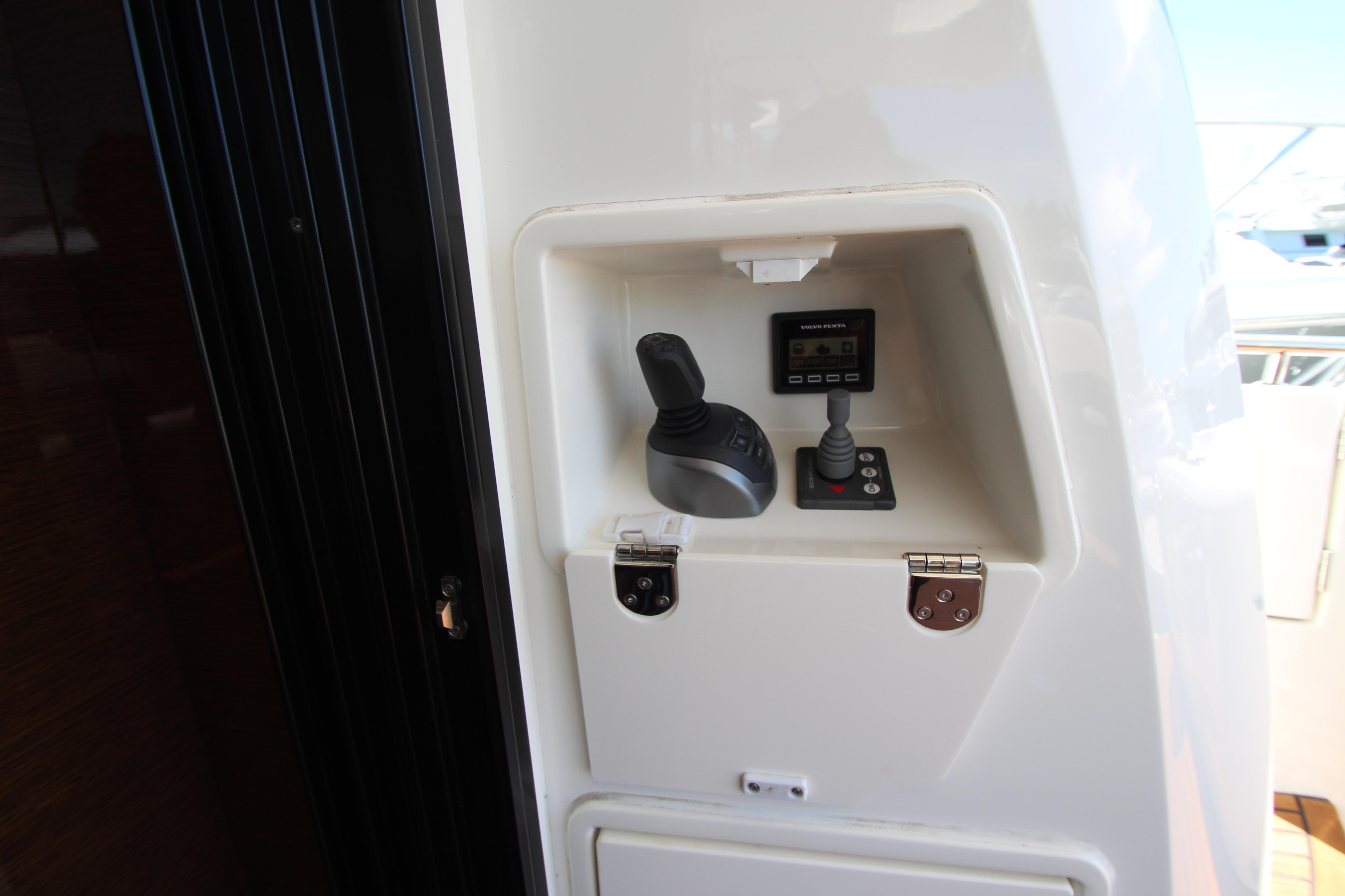 Control panel of a 2022 Prestige 520 yacht featuring joystick and display.