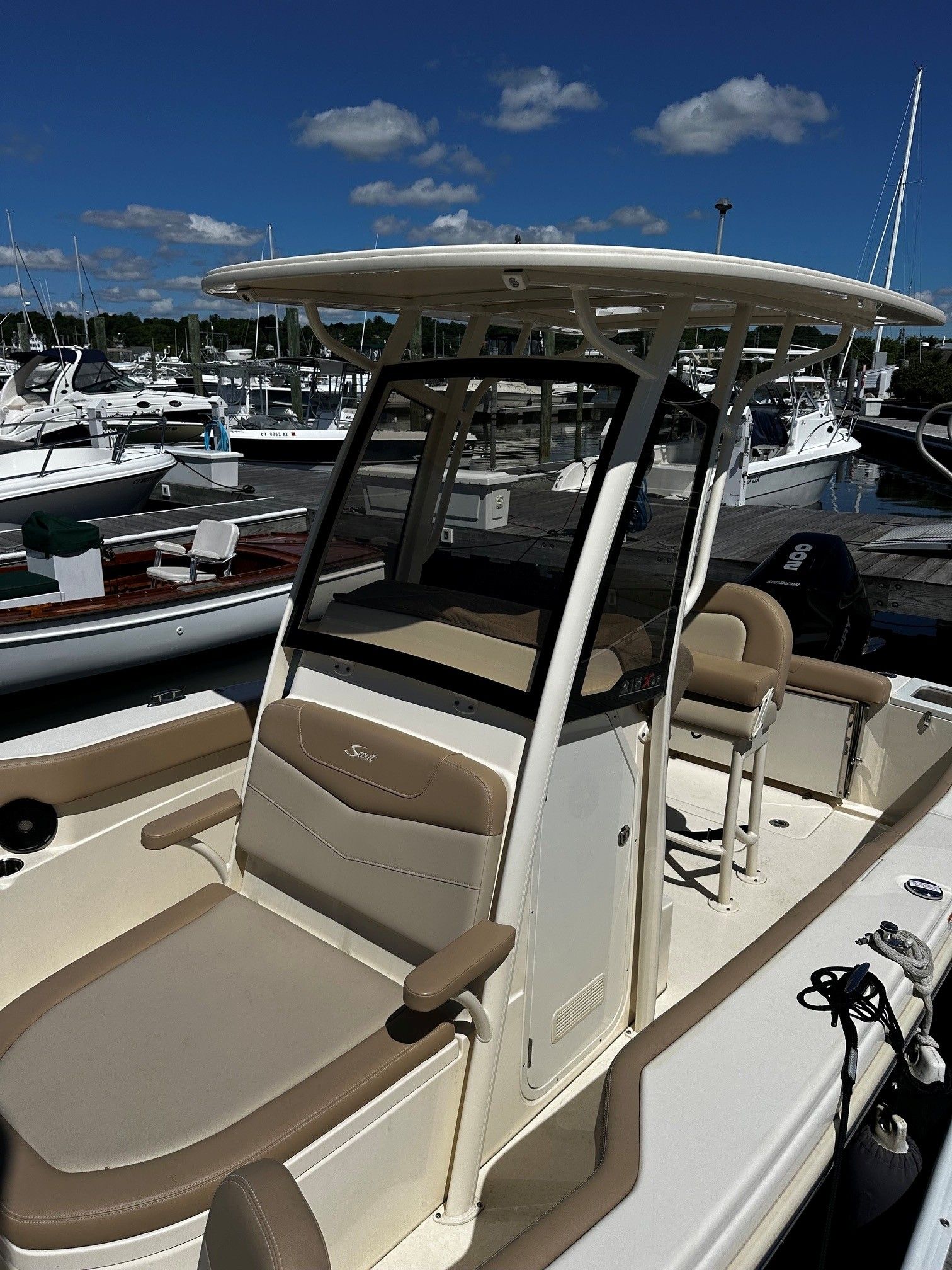 Scout 210XSF 2022 boat docked at marina on a sunny day.