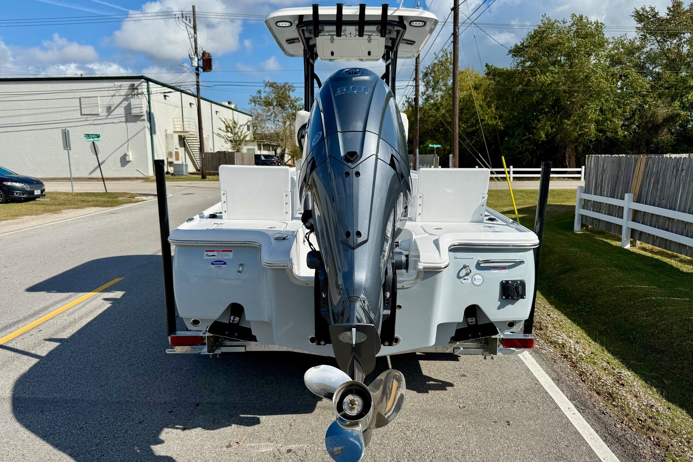 2026 Sea Hunt BX 22 BR boat with powerful outboard motor on a sunny street.