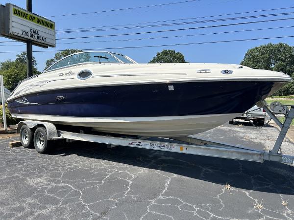 2005 Sea Ray 240 SD boat on trailer, parked outdoors.