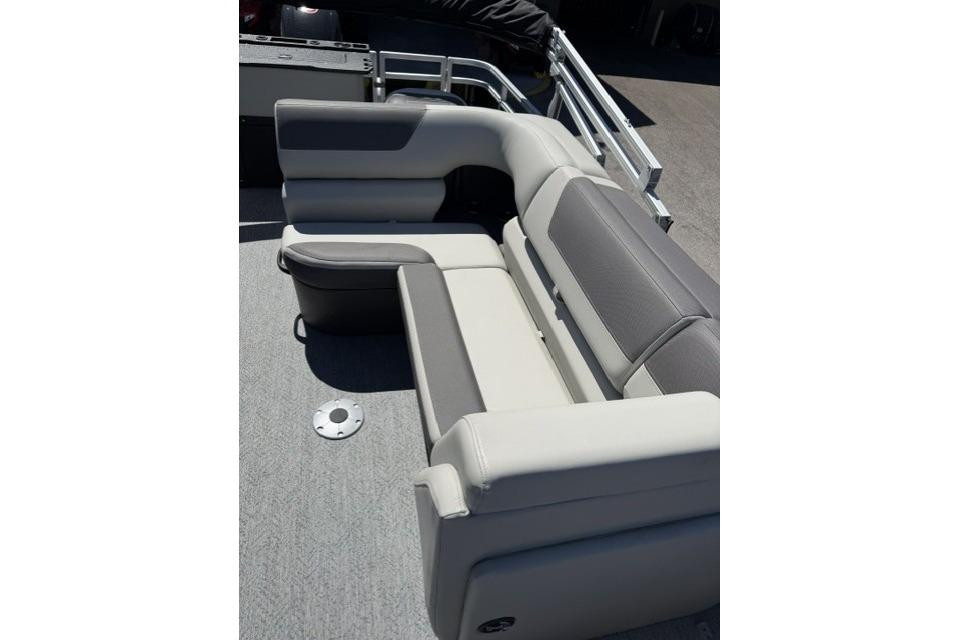 2026 Sun Tracker Fishin' Barge 20 DLX boat seating area, featuring comfortable gray and beige upholstery.
