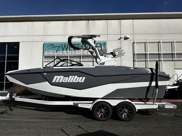 2025 Malibu M230 boat on trailer, parked outside West Coast Boat Center.