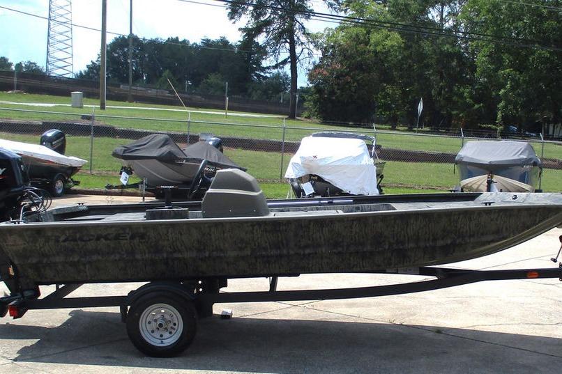 2026 Tracker GRIZZLY® 1648 SC boat on trailer, parked outdoors.