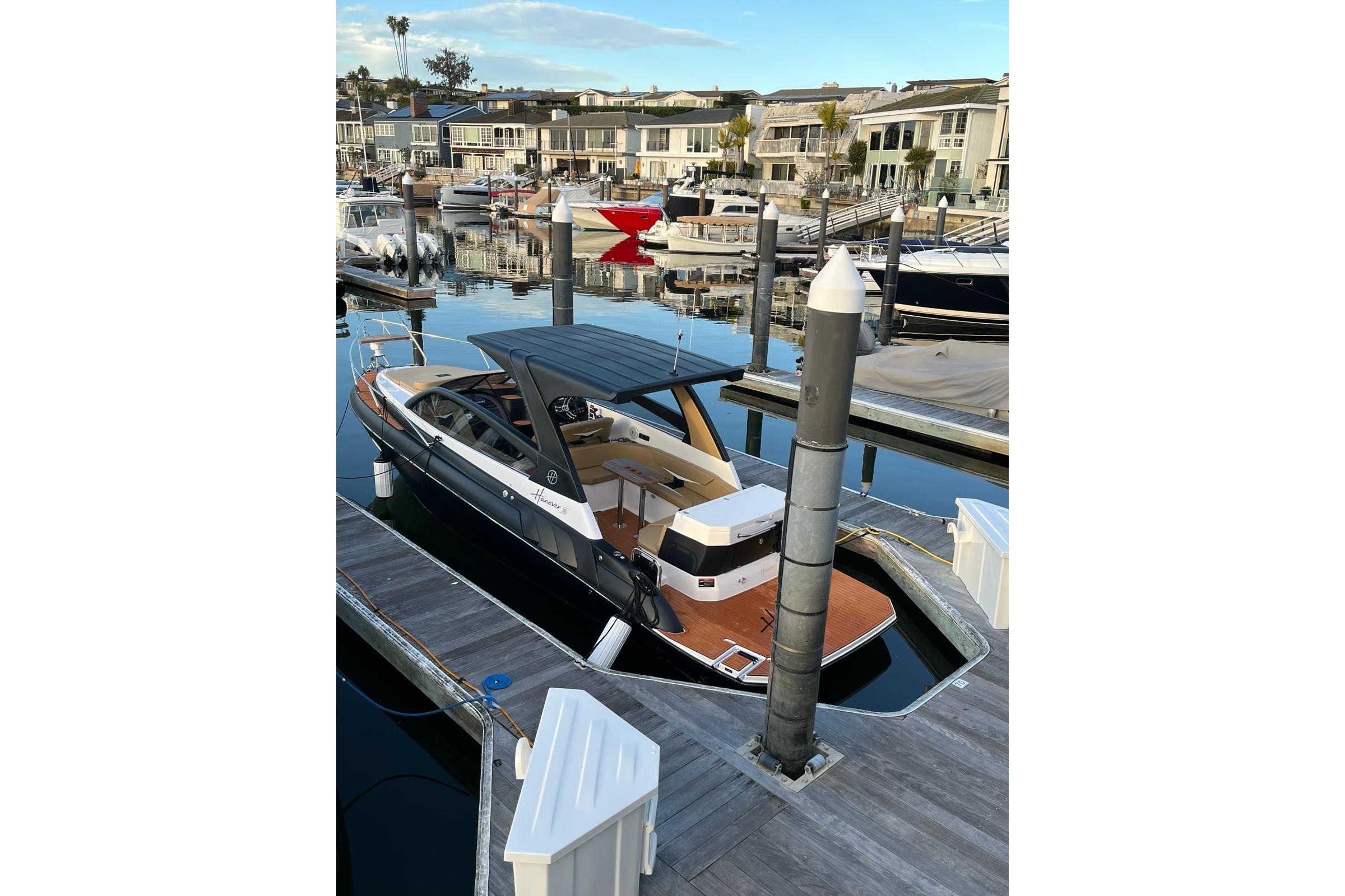 Luxury Hanover 305 boat docked at marina, 2026 model, sleek design.