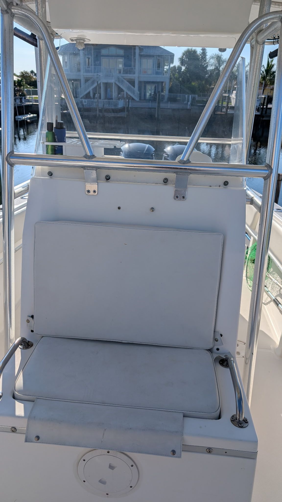 1997 Fountain Center Console boat with seating, docked by the water.
