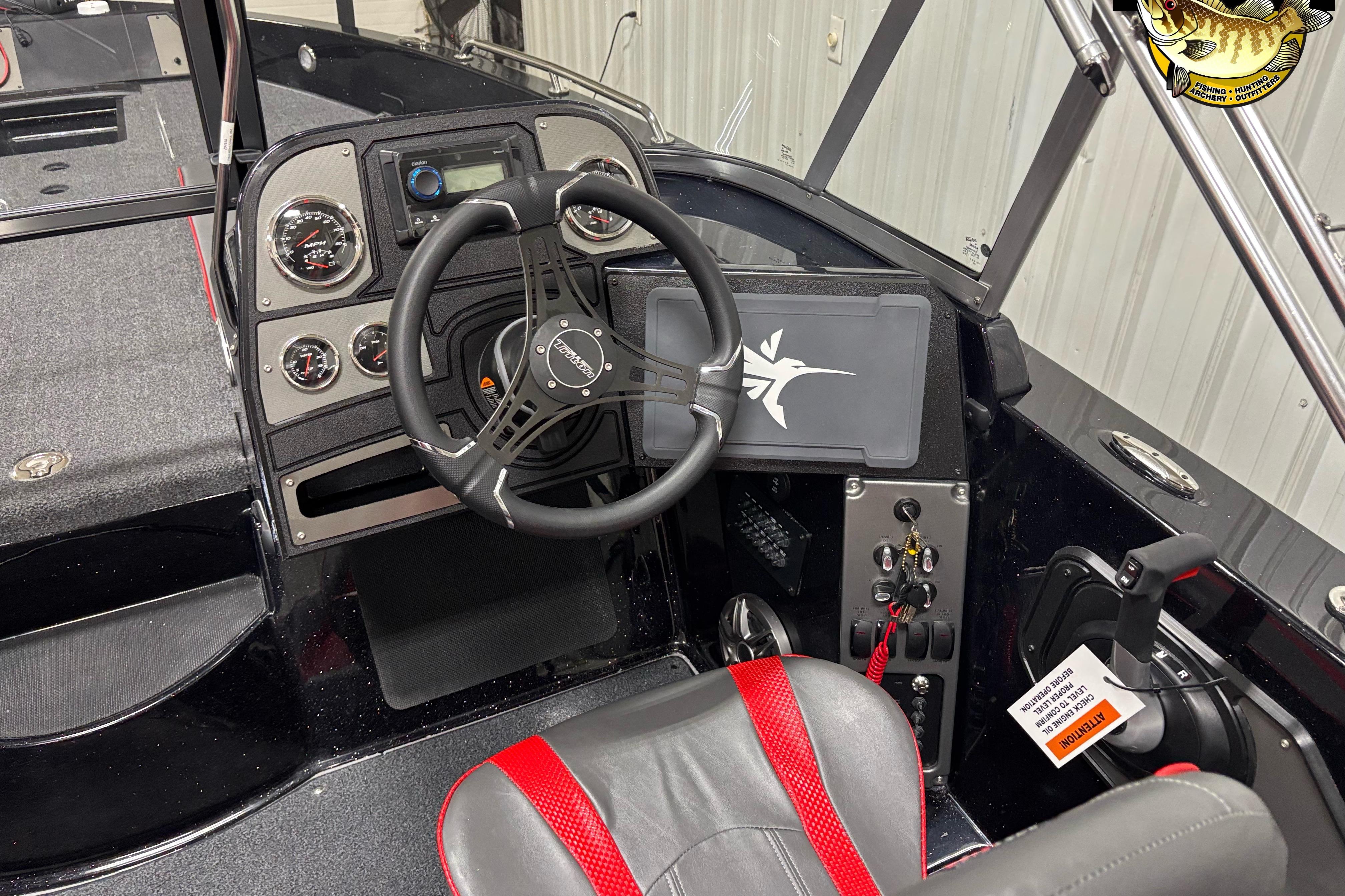 Interior of 2026 Triton 206 Allure boat, featuring steering wheel and control panel.