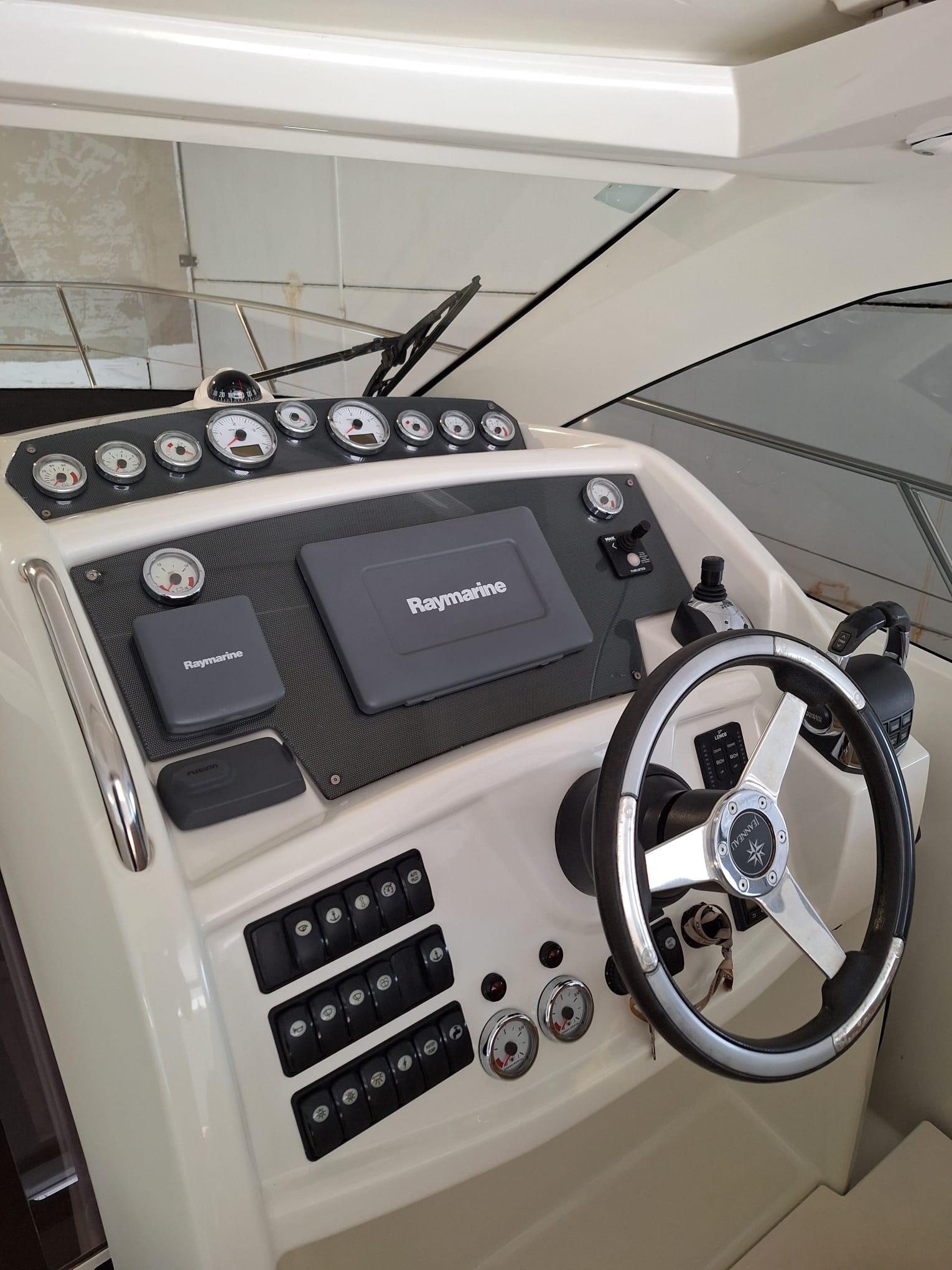Control panel of 2012 Jeanneau Leader 10 boat with steering wheel and gauges.
