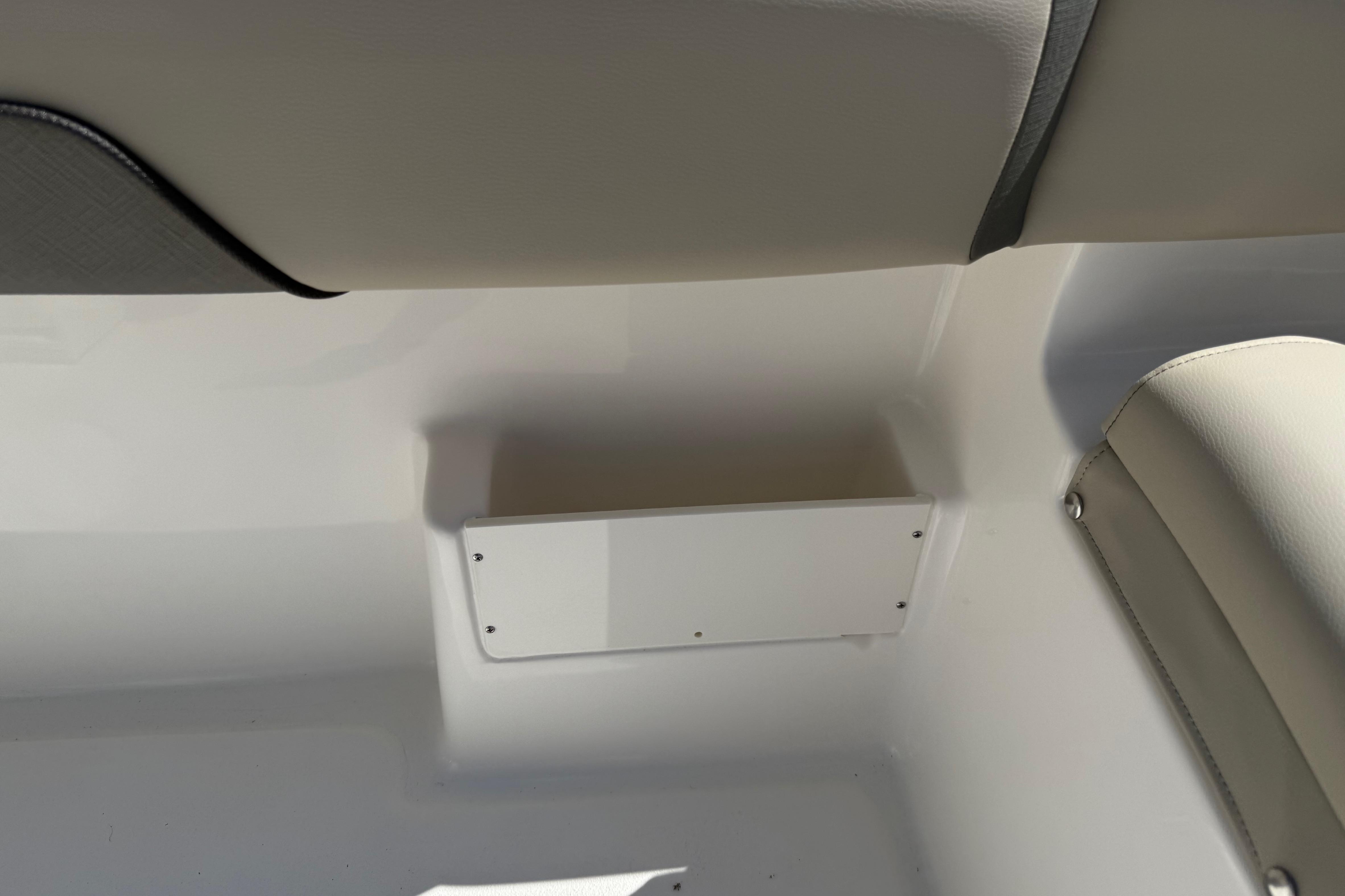 Interior detail of 2026 Key West 239 FS boat, featuring seating and storage area.