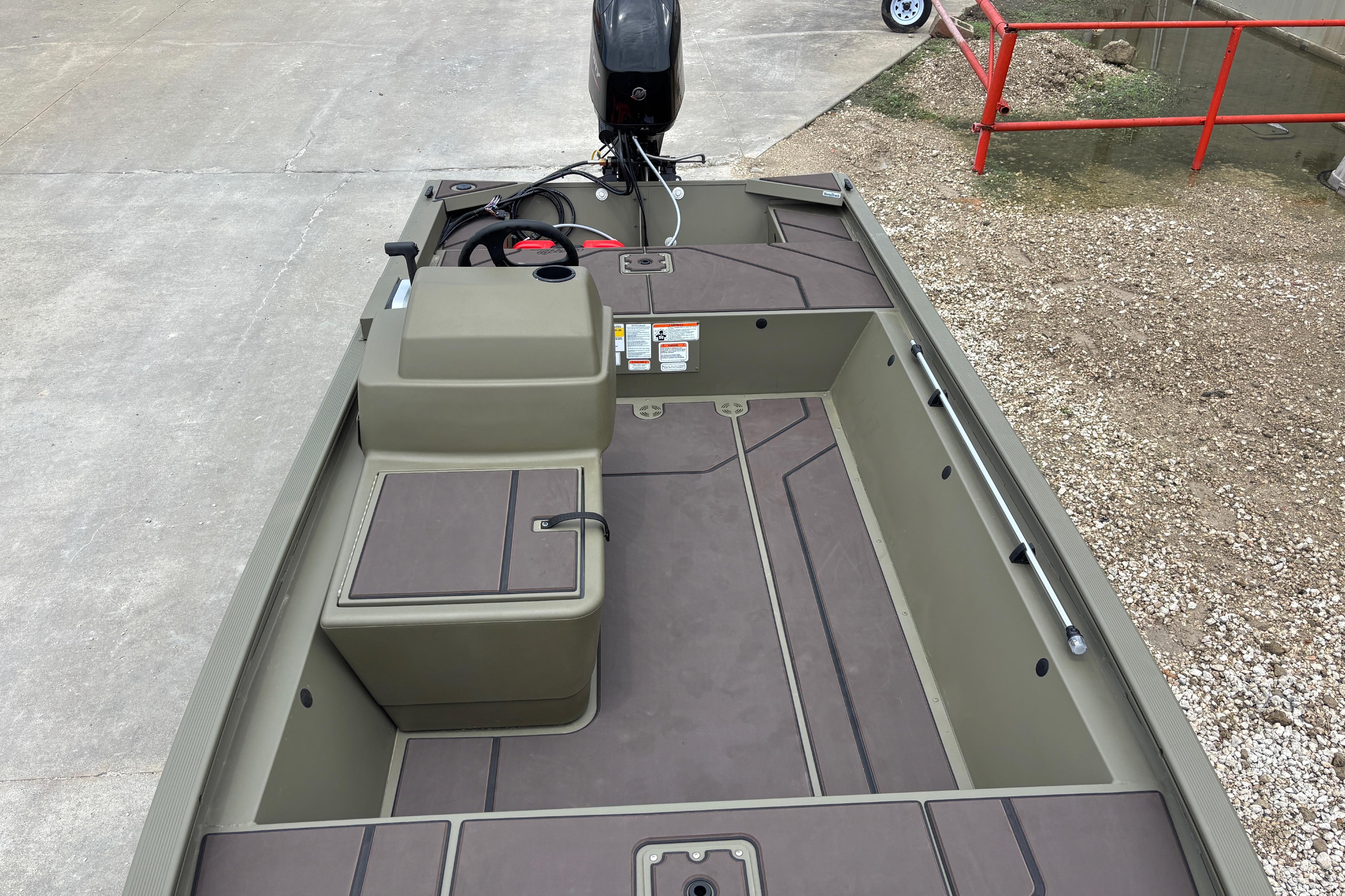 2026 Tracker Grizzly 1648 SC boat interior with steering console and storage compartments.
