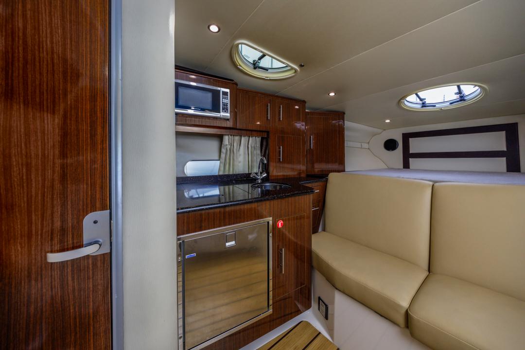 2014 Regal 32 Express interior with kitchenette, seating, and modern amenities.
