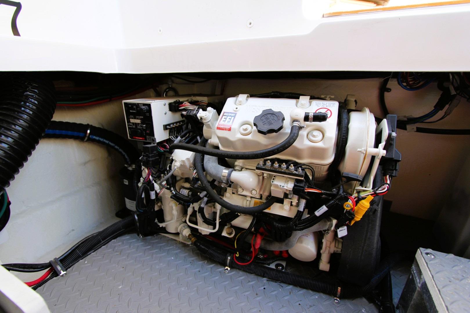 Engine compartment of a 2021 Sea Ray Sundancer 320 Outboard, showcasing detailed mechanical components.