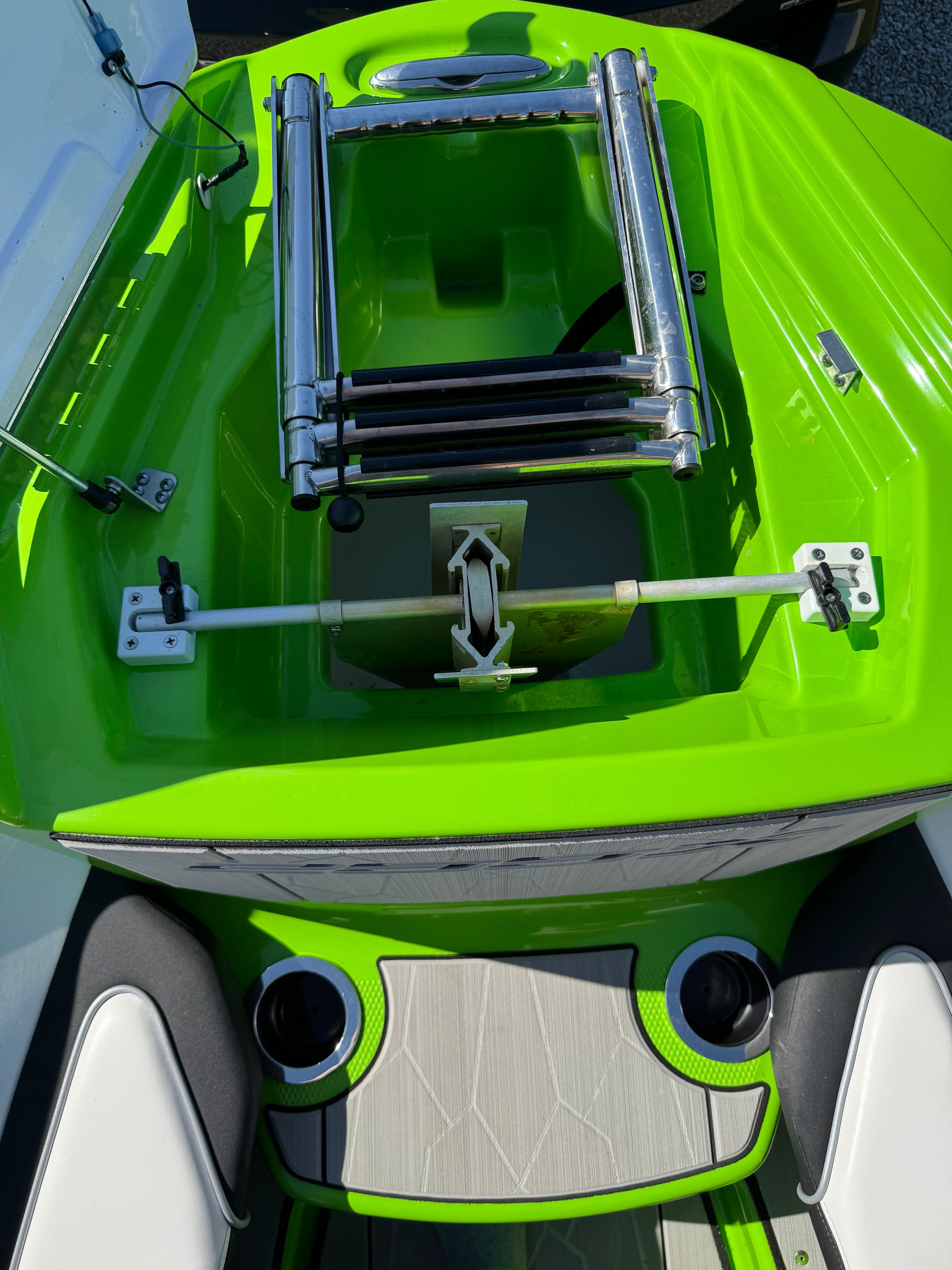 Green area of a Yamaha 255XD boat with stainless steel ladder and cup holders.