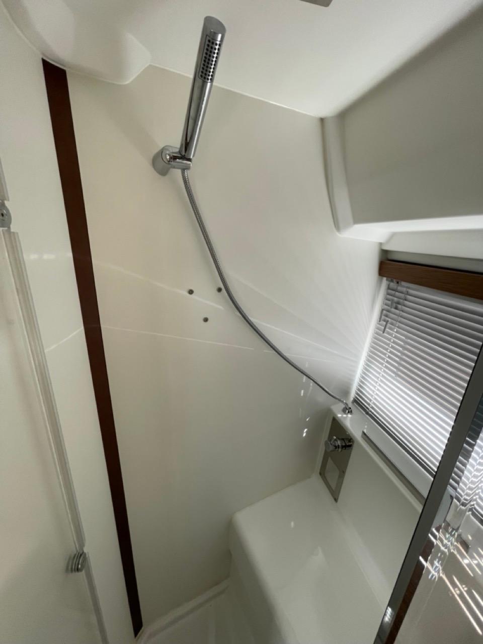 Shower area in 2020 Jeanneau NC 37 boat with modern fixtures and window blinds.