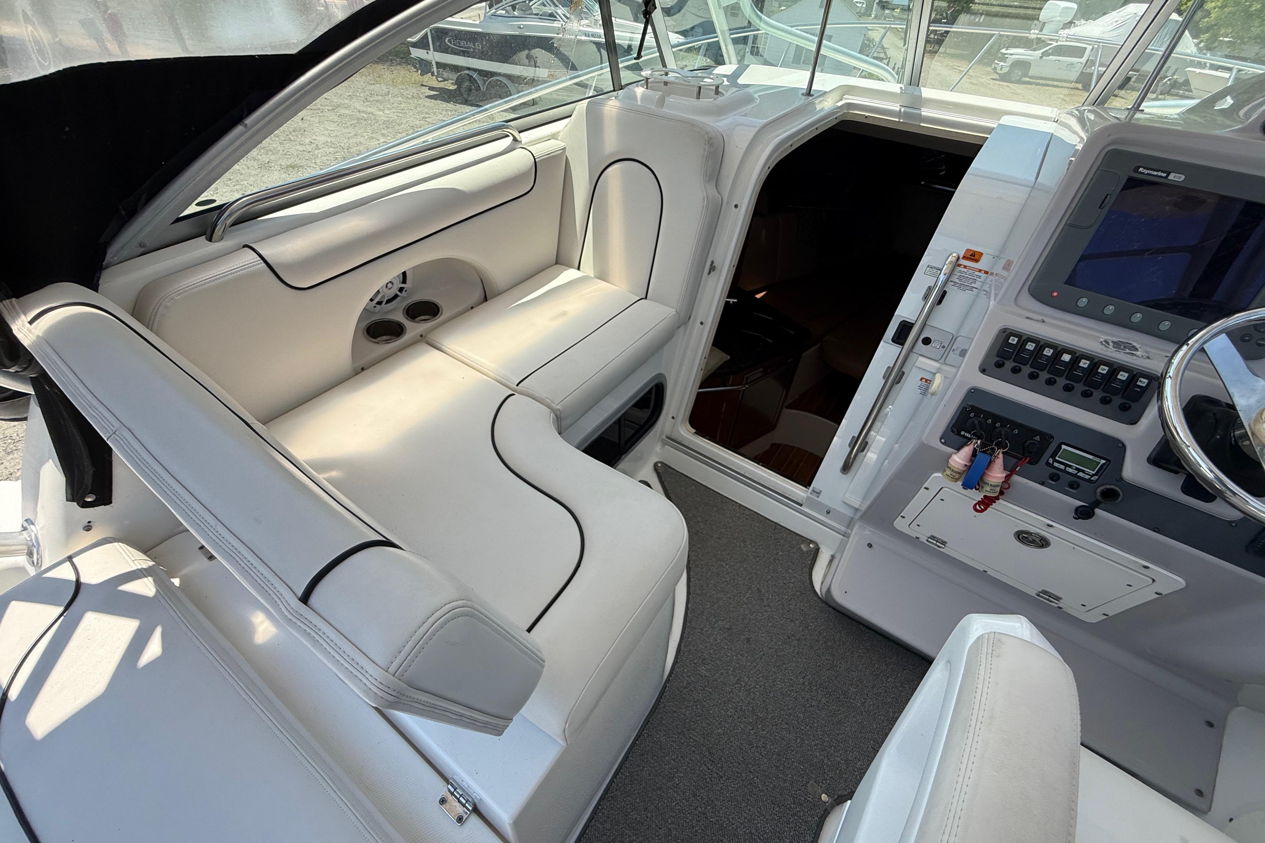 2007 Robalo R305 Walkaround boat interior with white seating and control panel.