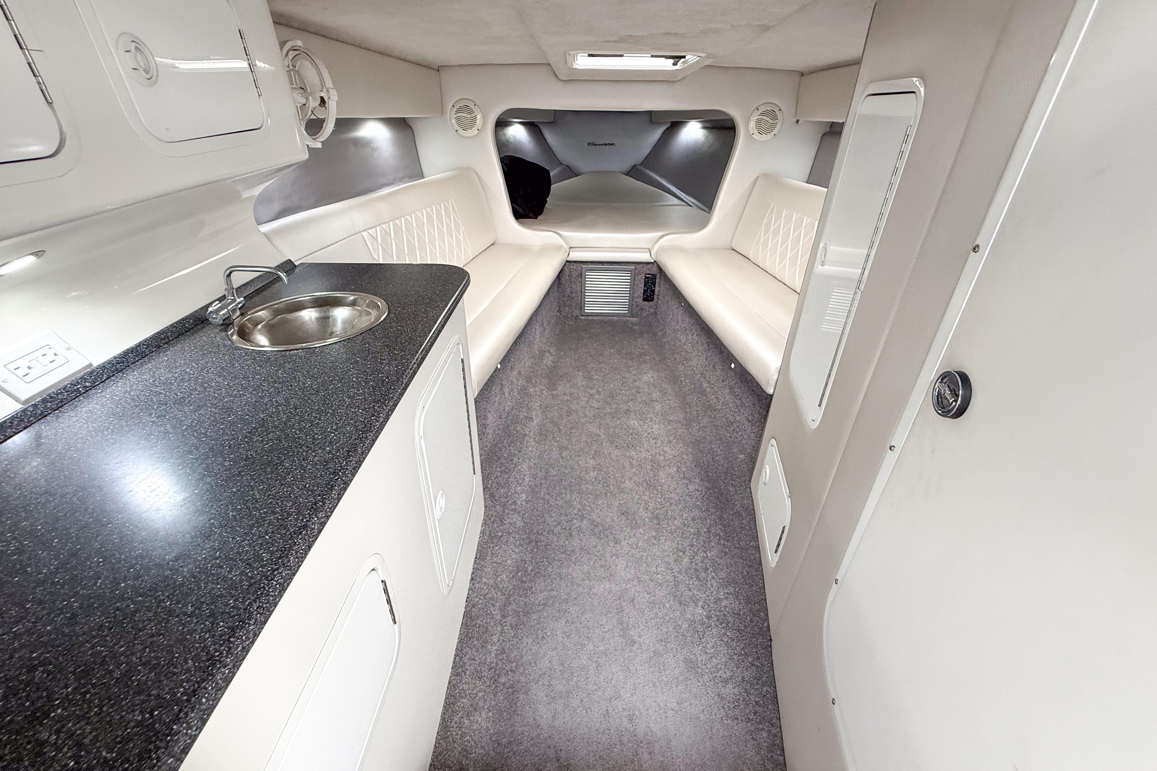 Interior of 2002 Active Thunder 37 boat with seating, sink, and modern amenities.