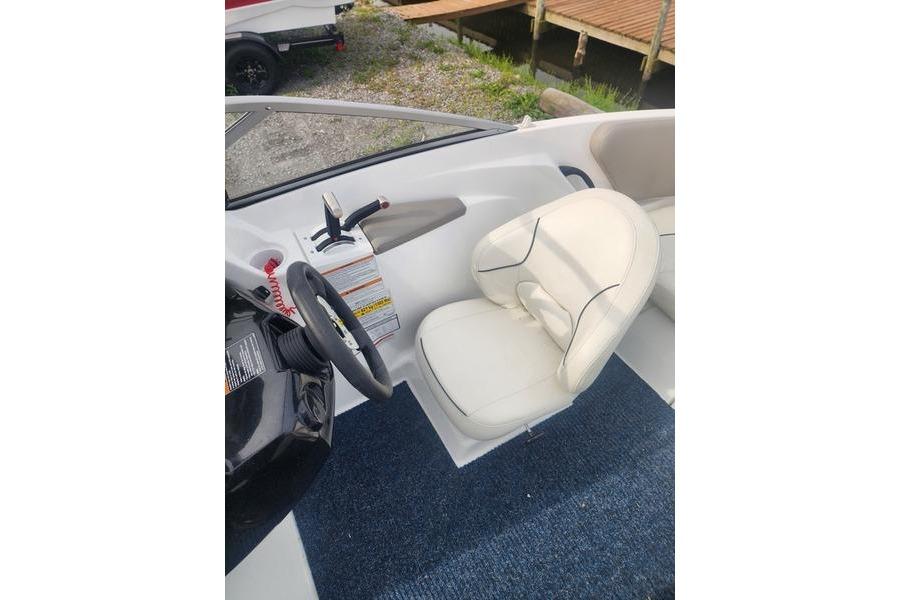 2012 Sea-Doo 180 Challenger boat interior with steering wheel and white seat.