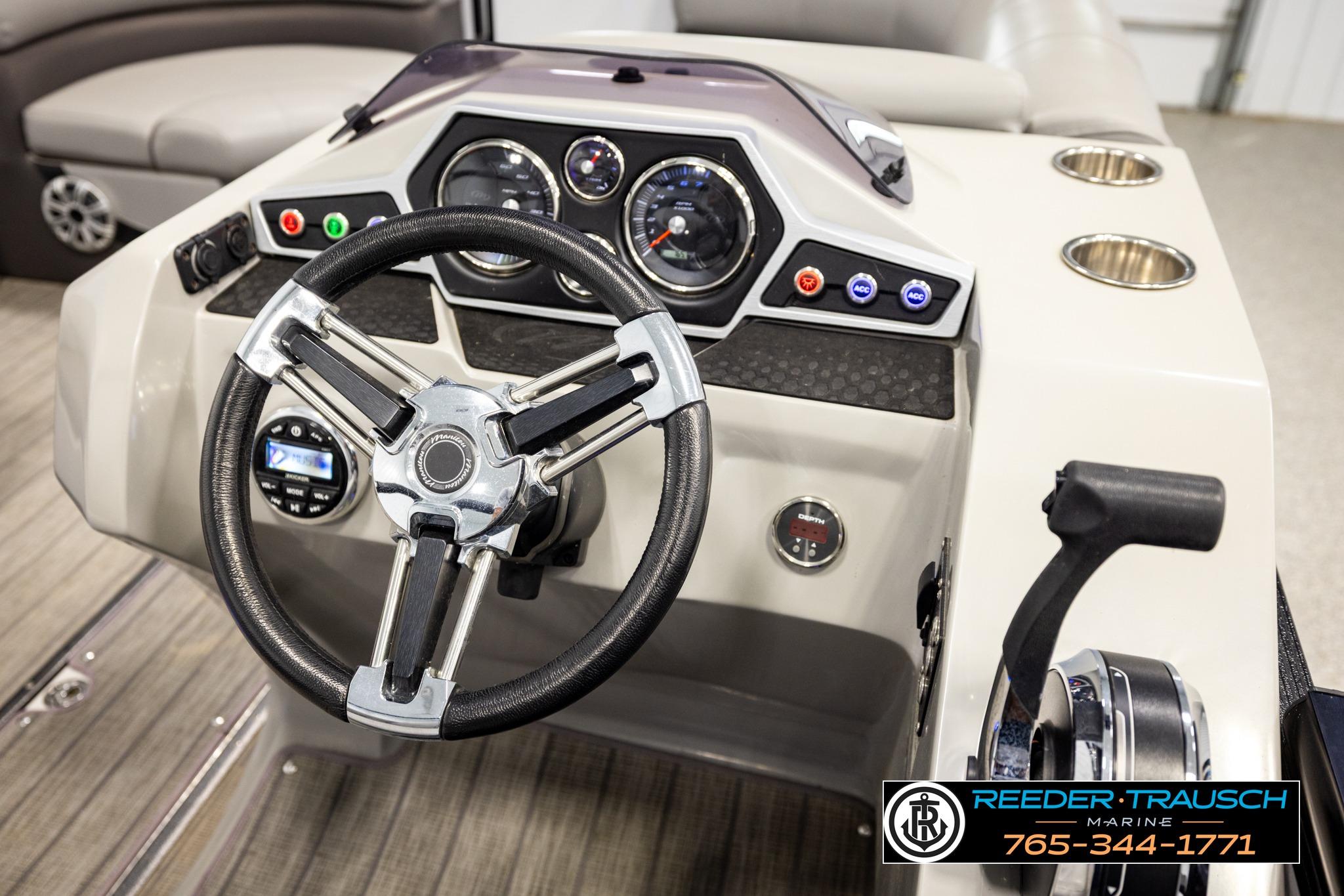 2019 Manitou Oasis SR VP boat dashboard with steering wheel and control panel.