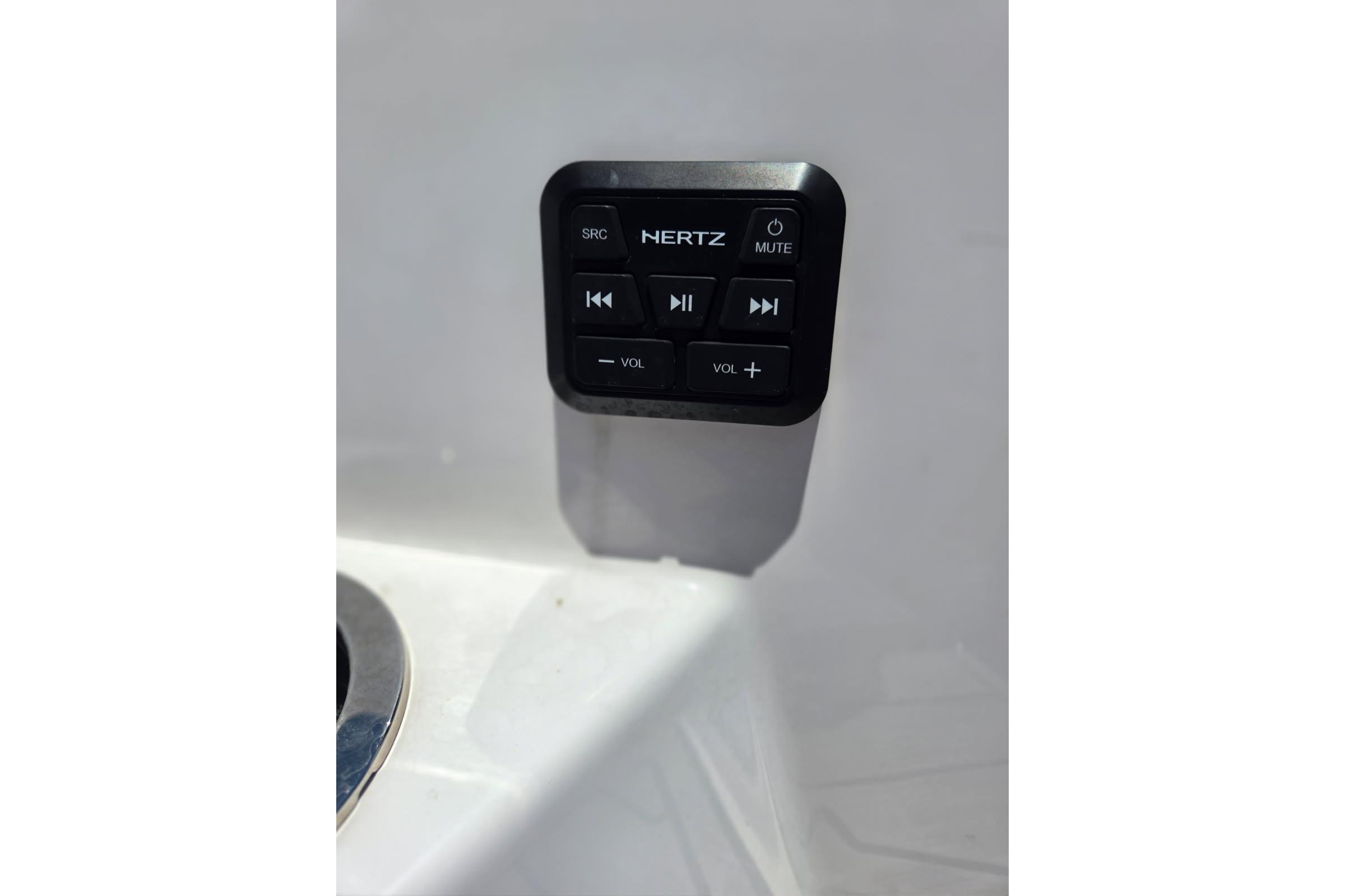 Control panel on 2024 Yamaha Boats 222 FSH Sport E, featuring audio system buttons.