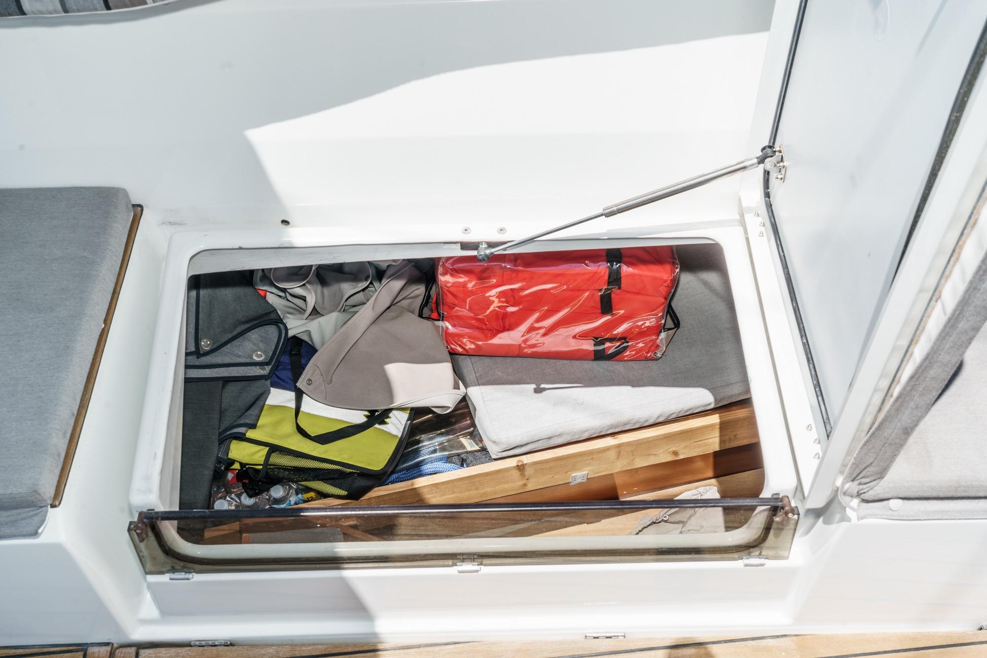 Storage compartment on a 2017 Beneteau Sense 50 yacht, containing various items.