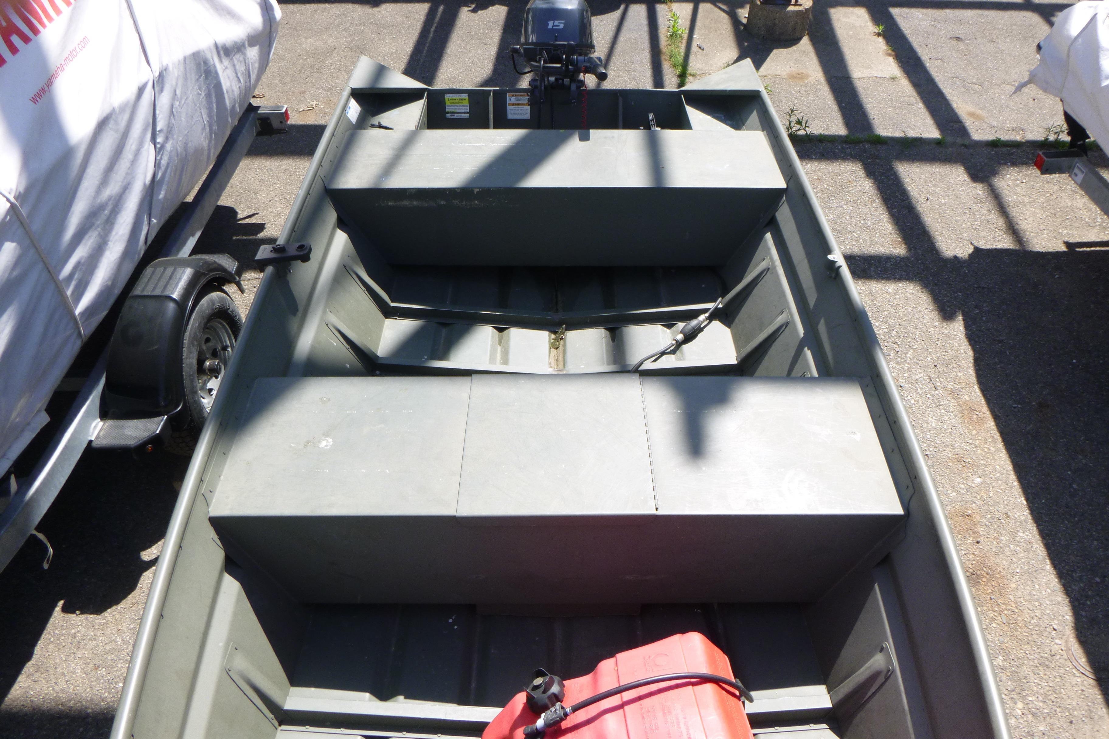 2014 Polar Kraft Jon MV 1448 LW boat with motor, parked on pavement.