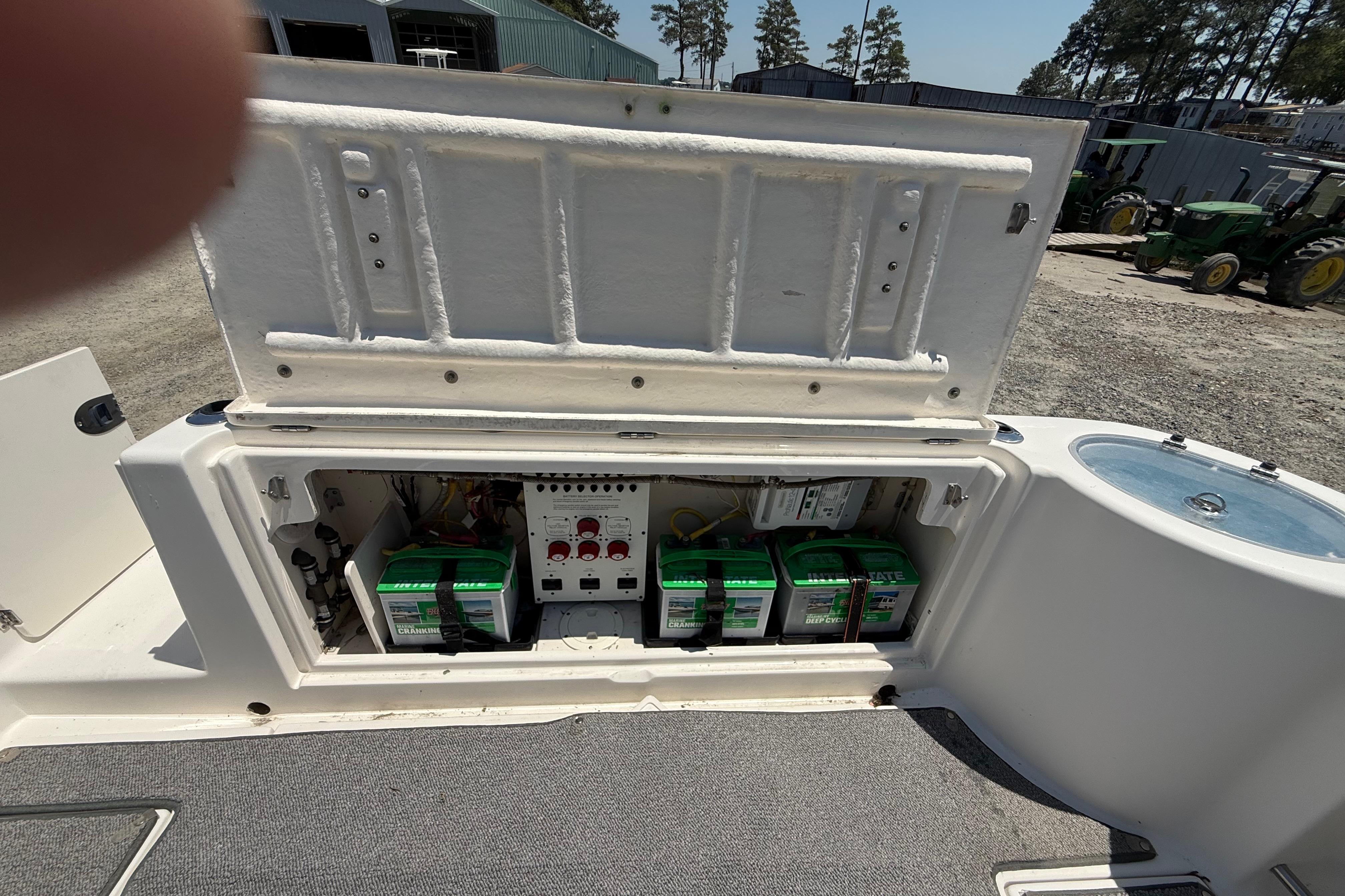 2007 Robalo R305 Walkaround boat battery compartment with multiple batteries and control panel.