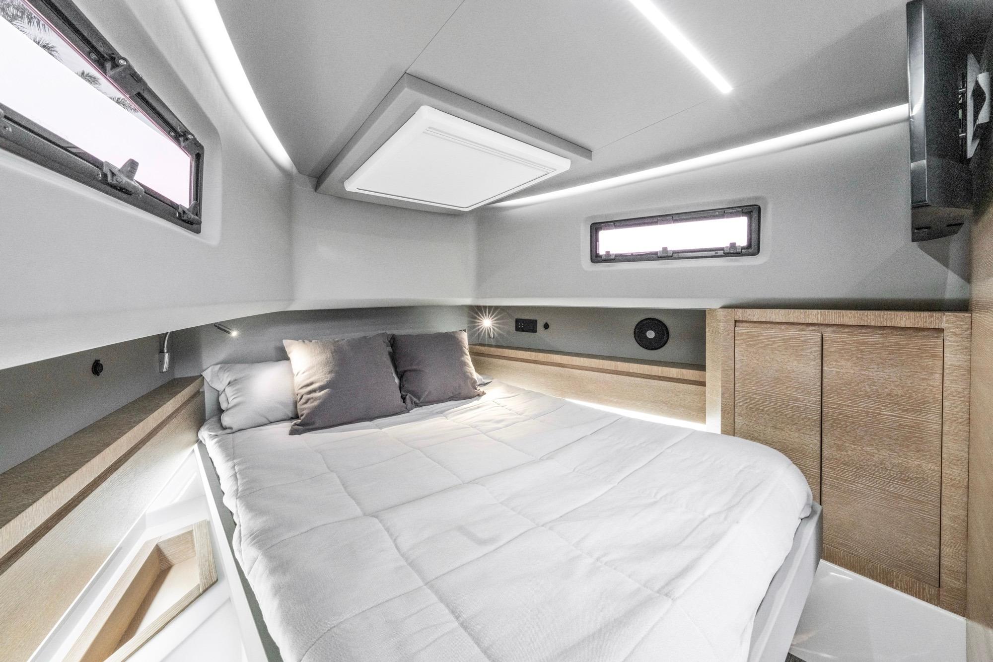 Luxurious cabin interior of 2024 Astondoa 377 Coupe yacht, featuring modern design and comfortable bedding.