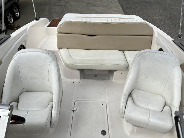 2013 Regal 1900 boat interior with white seating and beige backrest.