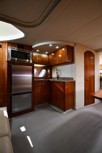 Interior of 2010 Cruisers Yachts 390 Sports Coupe with modern kitchen amenities.