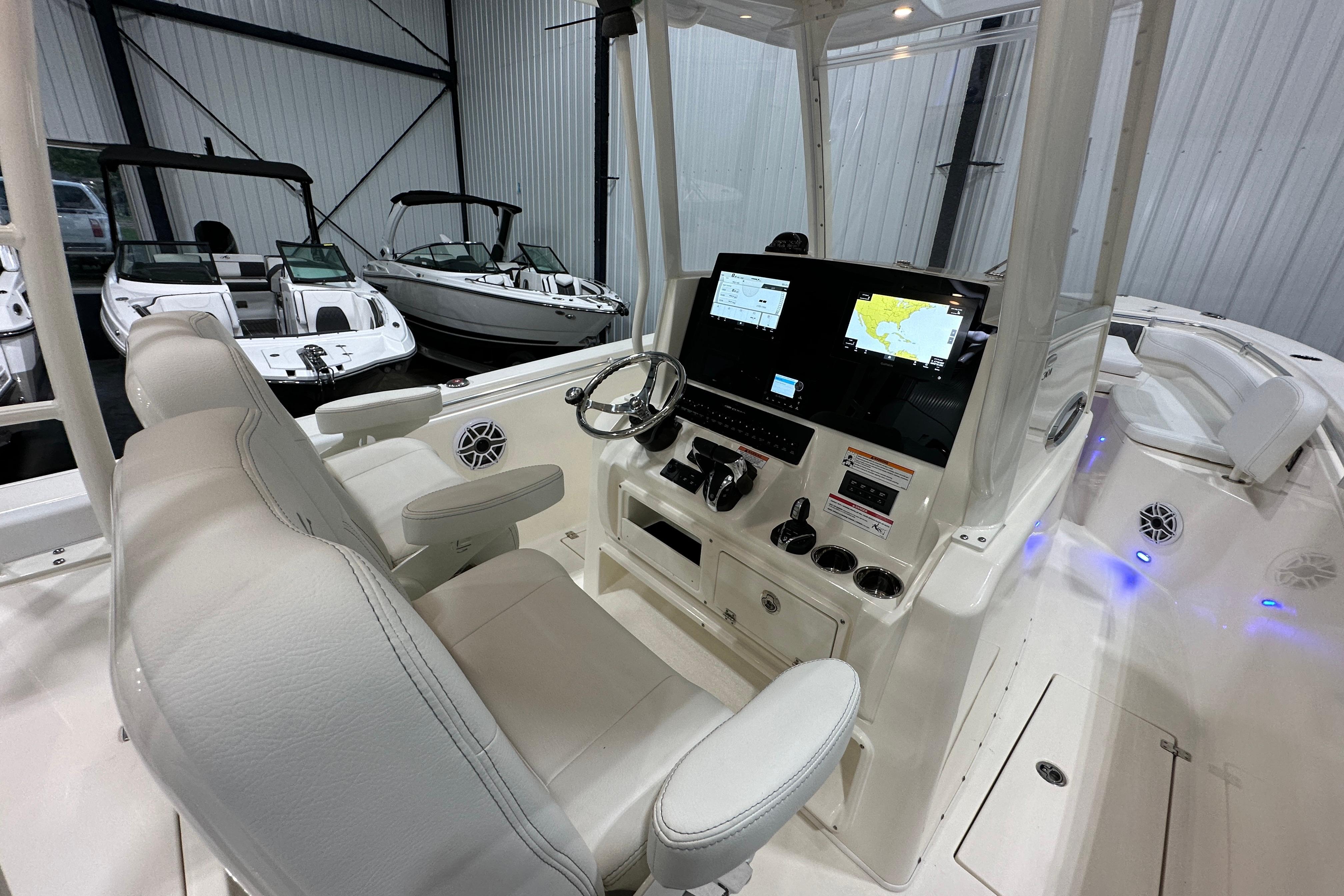 2024 Cobia 301 Center Console boat interior with modern navigation system and comfortable seating.