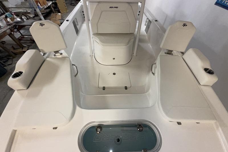 2026 Sea Pro 250 Bay boat interior with seating and storage compartments.