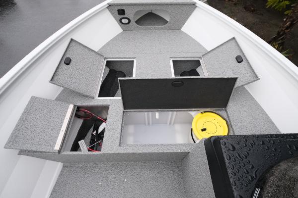 2024 Crestliner 1600 Vision boat with open storage compartments and a yellow bucket.